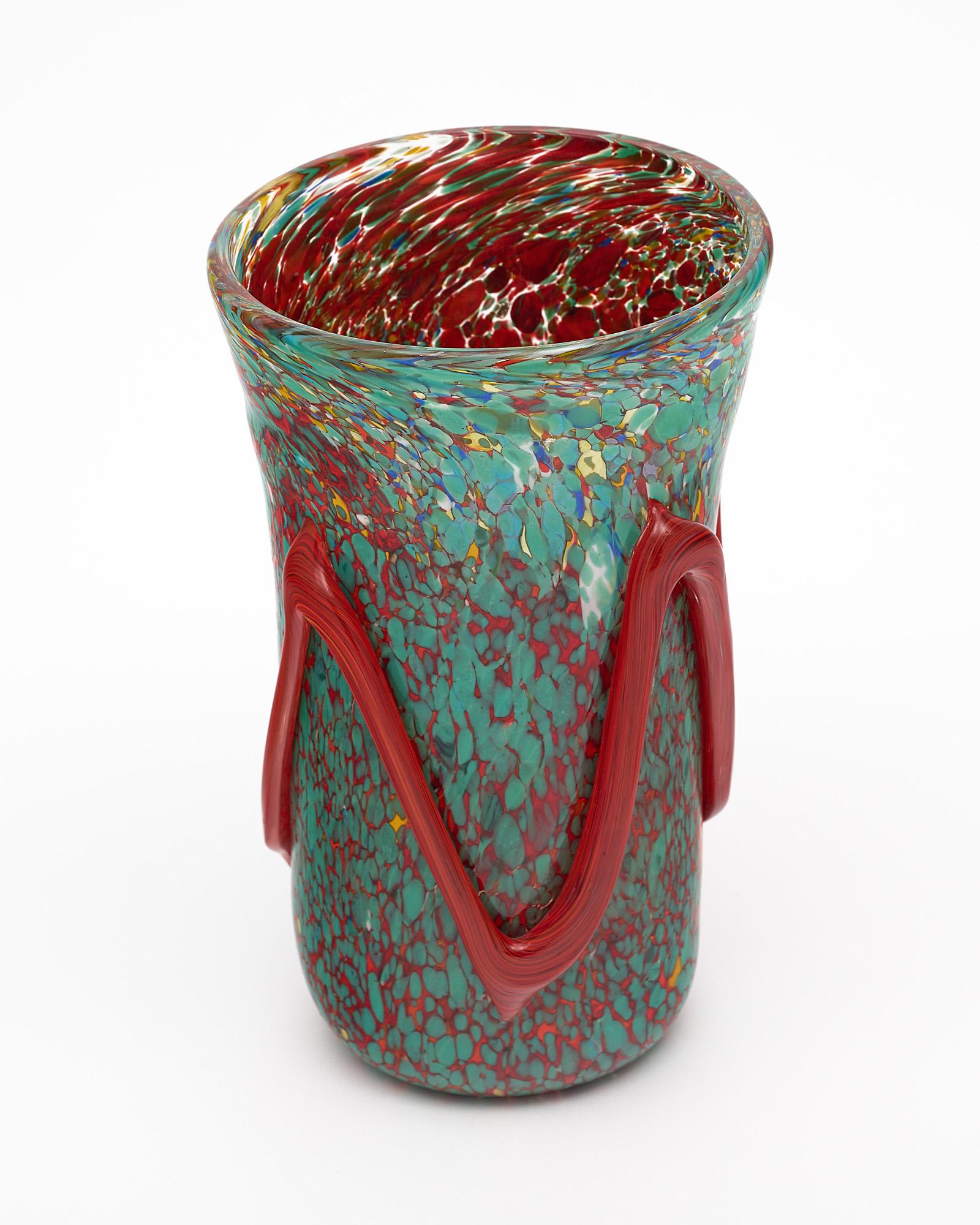 Murano glass vase from Murano, Italy. This piece is hand-blown glass with striking colors and technique. We love the organic movement of the pattern and details.