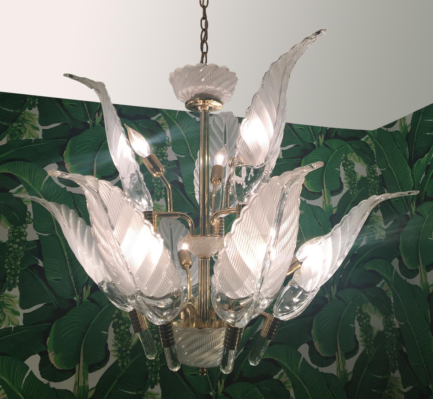 Sculptural glass palm leaf chandelier by Murano features brass frame and nine lights. Clear glass fronds measure 18
