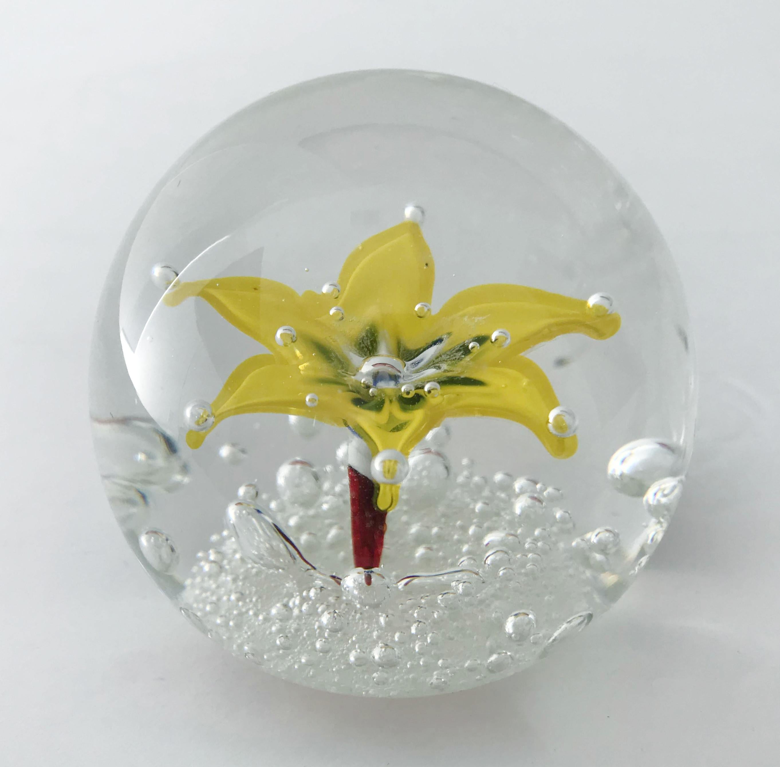 Vintage Italian hand blown Murano glass paperweight with a large yellow flower and small bubbles using bollicine technique by Ferro & Lazzarini, made in Italy, circa 1960s
Original sticker on the bottom
Measures: diameter 2.75 inches, height 2.5