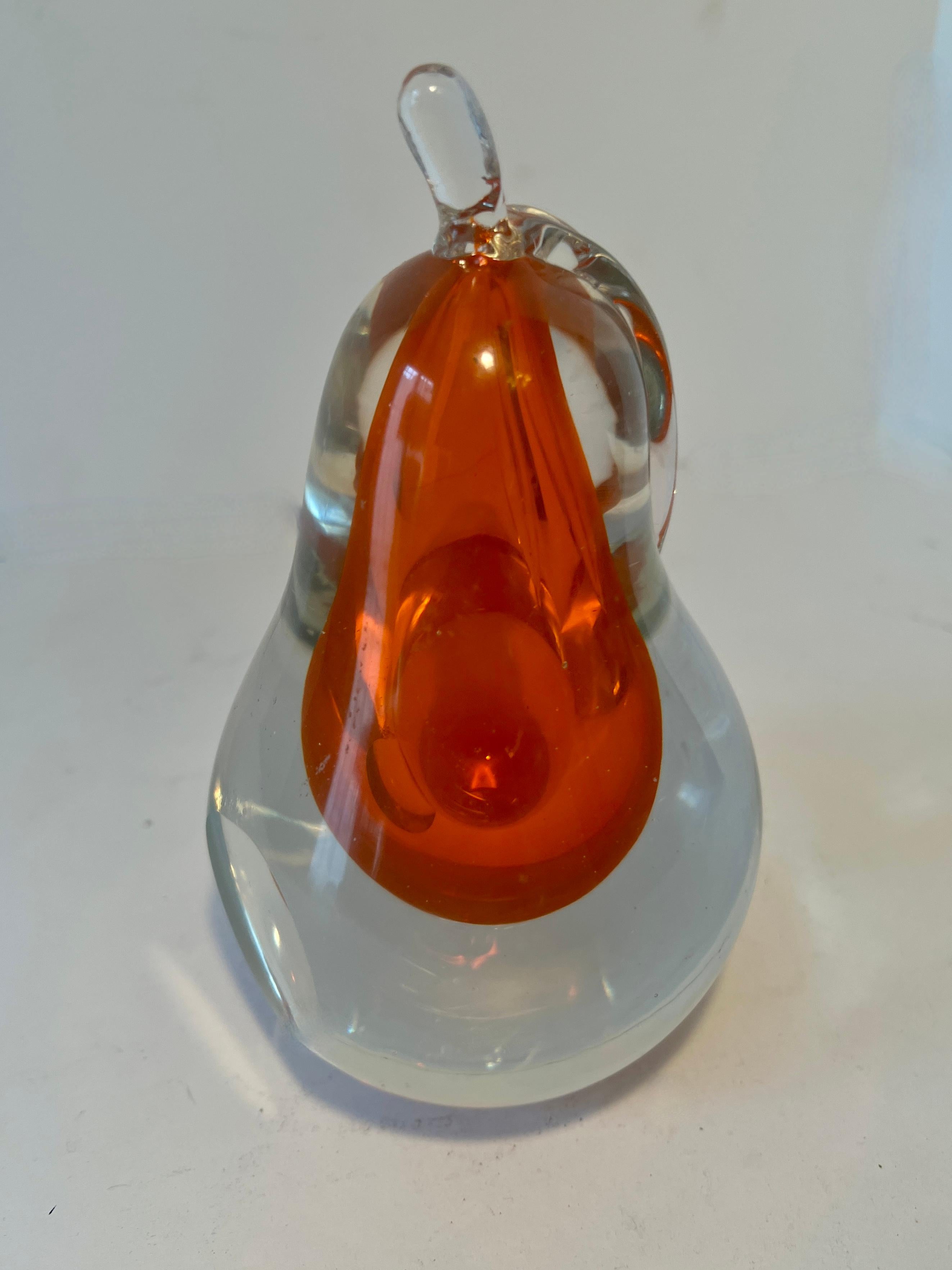 Art Glass Murano Hand Blown Pear Bookend or paperweight with interior burst of orange.

A wonderful mid century piece that can easily stand or lay on its side with a flattened side.  While the piece can be a bookend, or paperweight, it can also be a