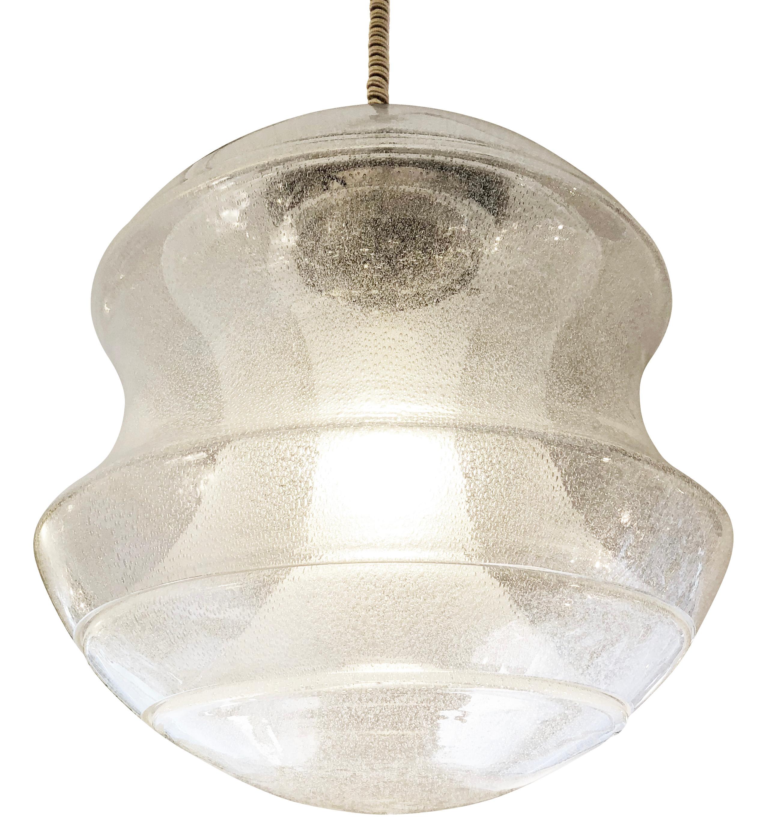 Beautiful hourglass shaped Murano glass pendant designed by Carlo Nason for Mazzega in the 1960s. Features three interlocking glasses made in the “Pulegoso” technique (glass with bubbles). Hardware is nickel and holds one Edison socket. Original