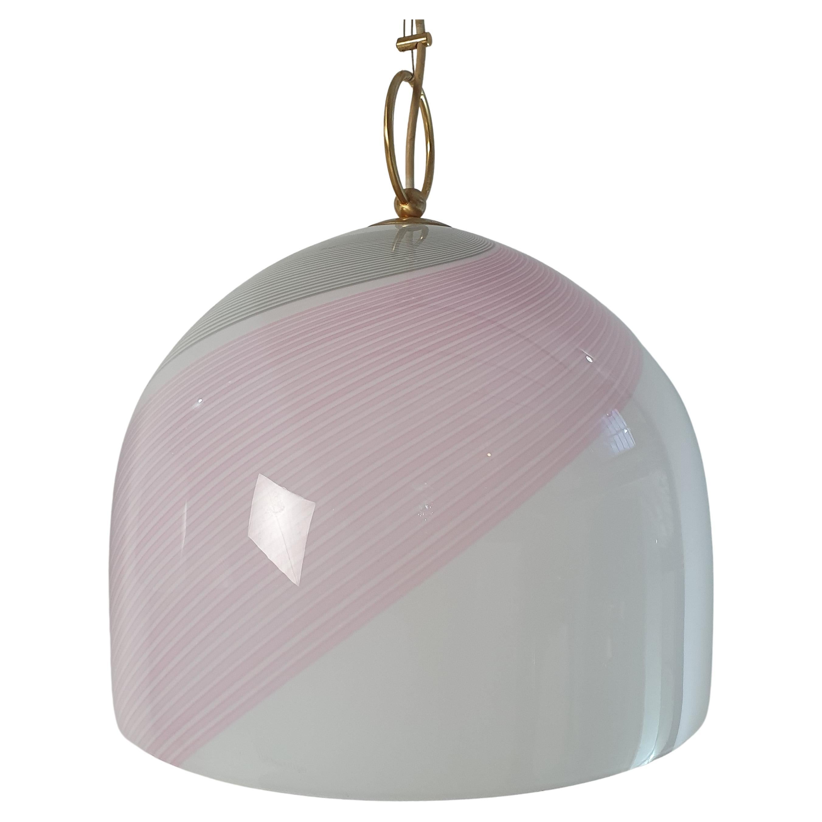 These exquisite pendant lights are a true Italian masterpiece, crafted by the renowned Lino Tagliapietra for La Murrina in Murano during the 1970s. Handmade with white glass as the base and delicate pink and gray lines, the bell-shaped design is a
