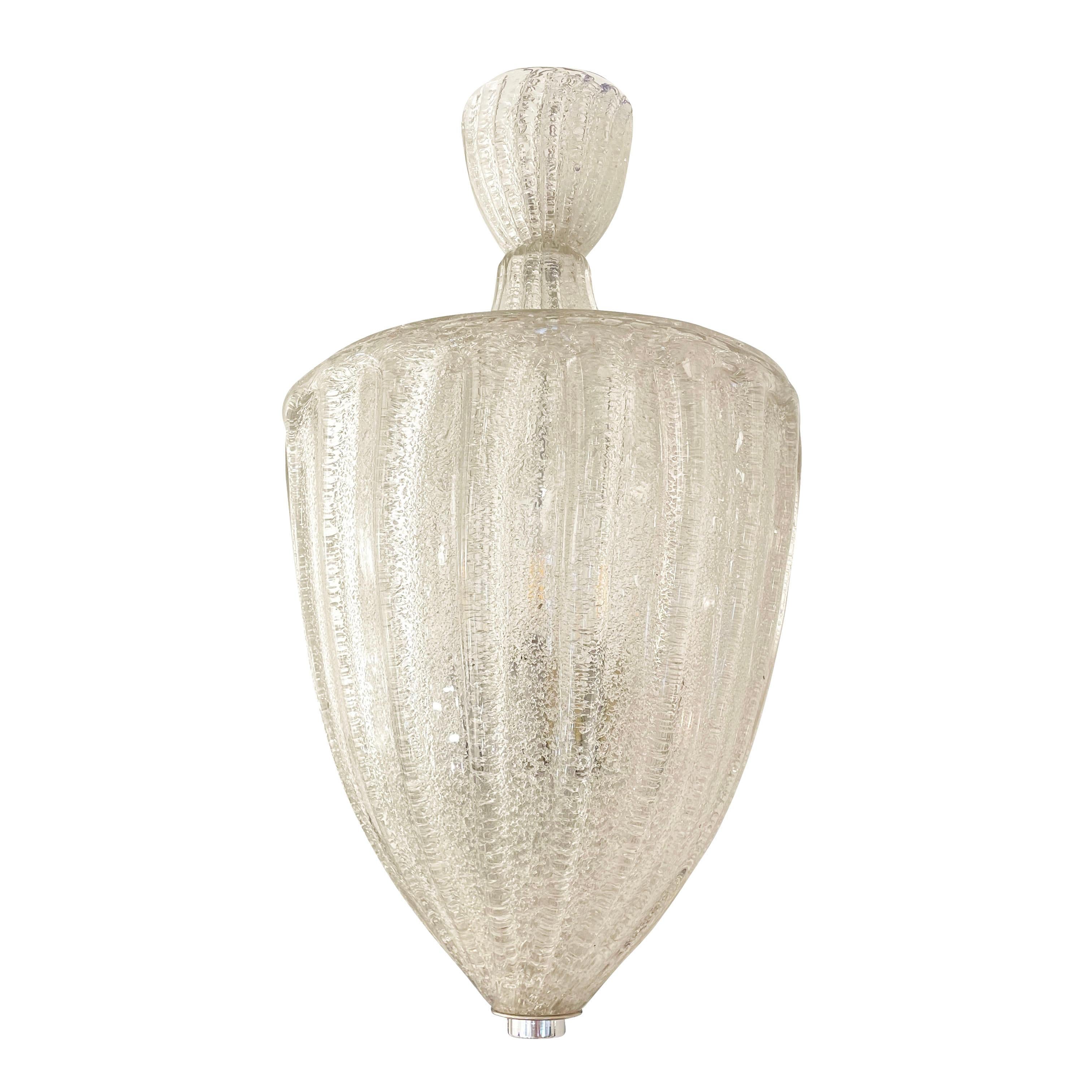 Italian mid-century murano glass pendant blown in a way that it is ribbed on the outside and textured on the inside. Composed of a main shade with nickel hardware and closed at the top with a glass lid and canopy. Holds two E26