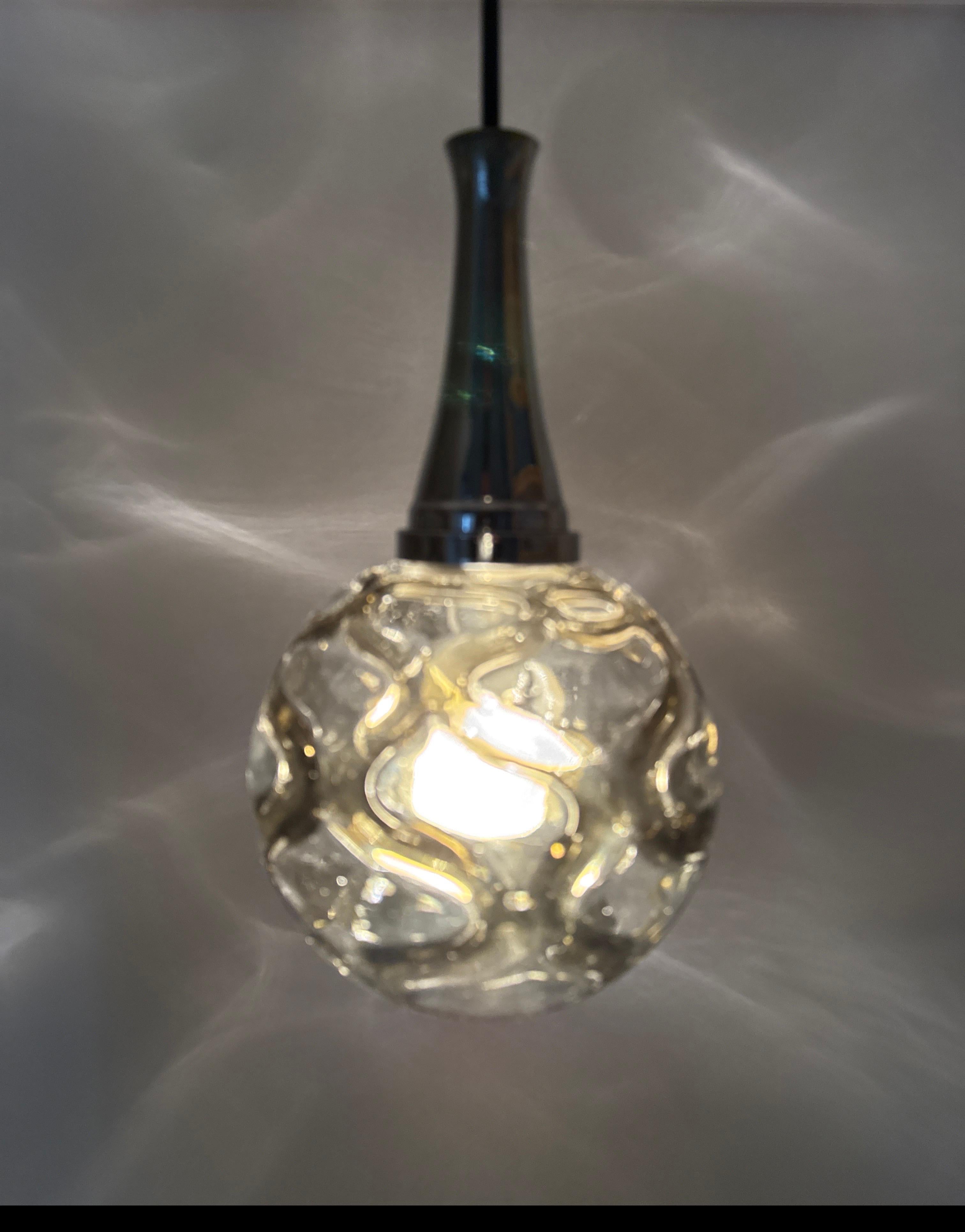 Beautiful handcrafted pendant lamp by Doria. This lamp is timelessly beautiful, the mouth-blown glass was made by master craftsmen, the decorations in a gray-green glass were applied by hand by the glass artist to the clear glass while it was still