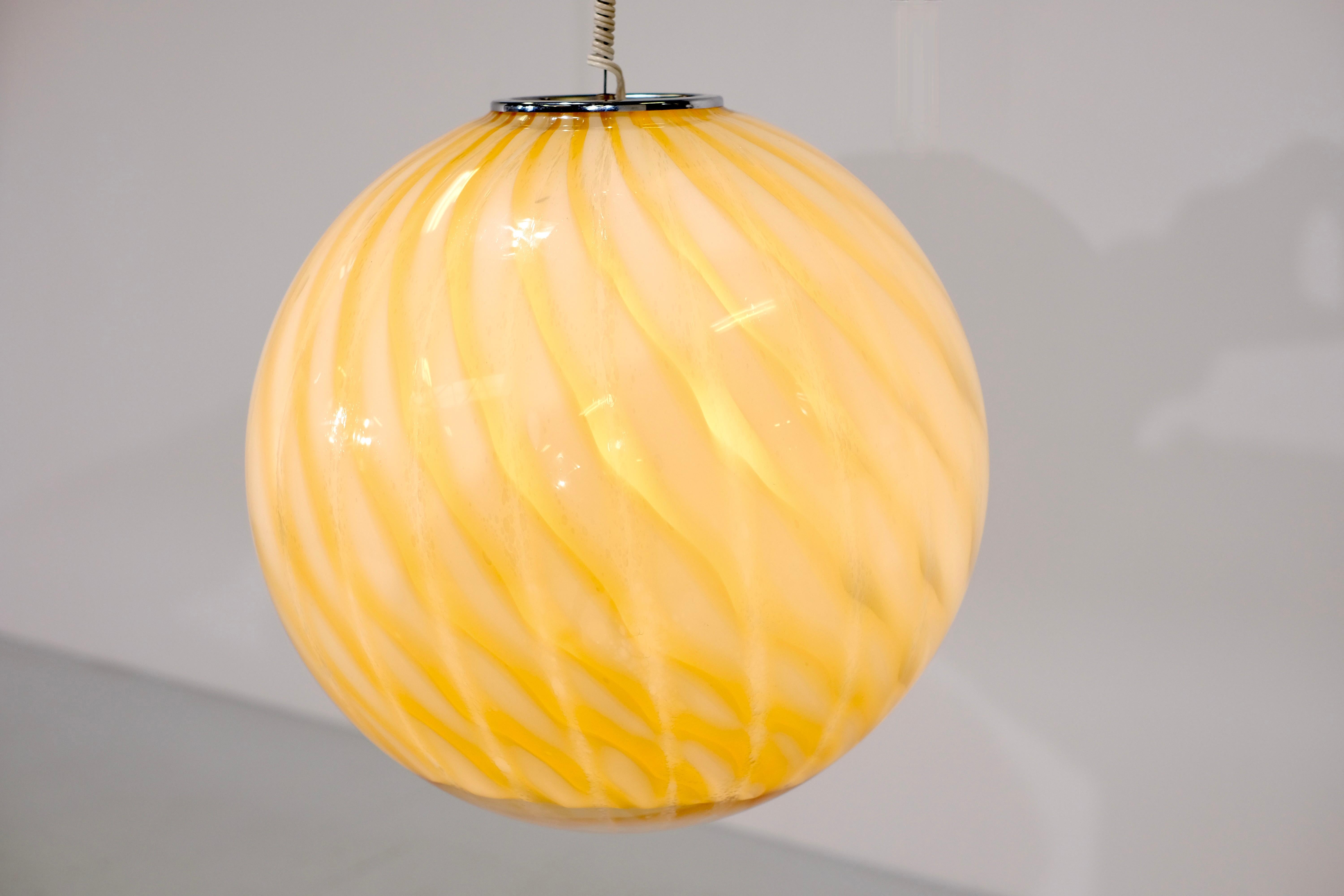 Erstaunliche kugelförmige Murano-Glas-Pendelleuchte, die Venini in den 1960er Jahren zugeschrieben wird.

Diese Hängelampe ist in einem wirklich tollen Vintage-Zustand und hat keine Schäden.
Der Farbverlauf der Muster bietet ein herrliches und