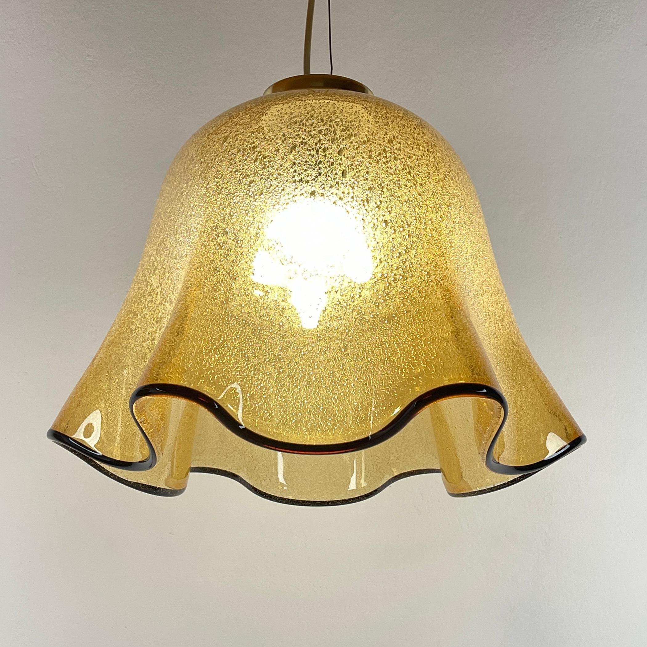 The beautiful Murano glass chandelier Fazzoletto Vetri Murano made in Italy in the 1970s. A yellow glass shade with a 