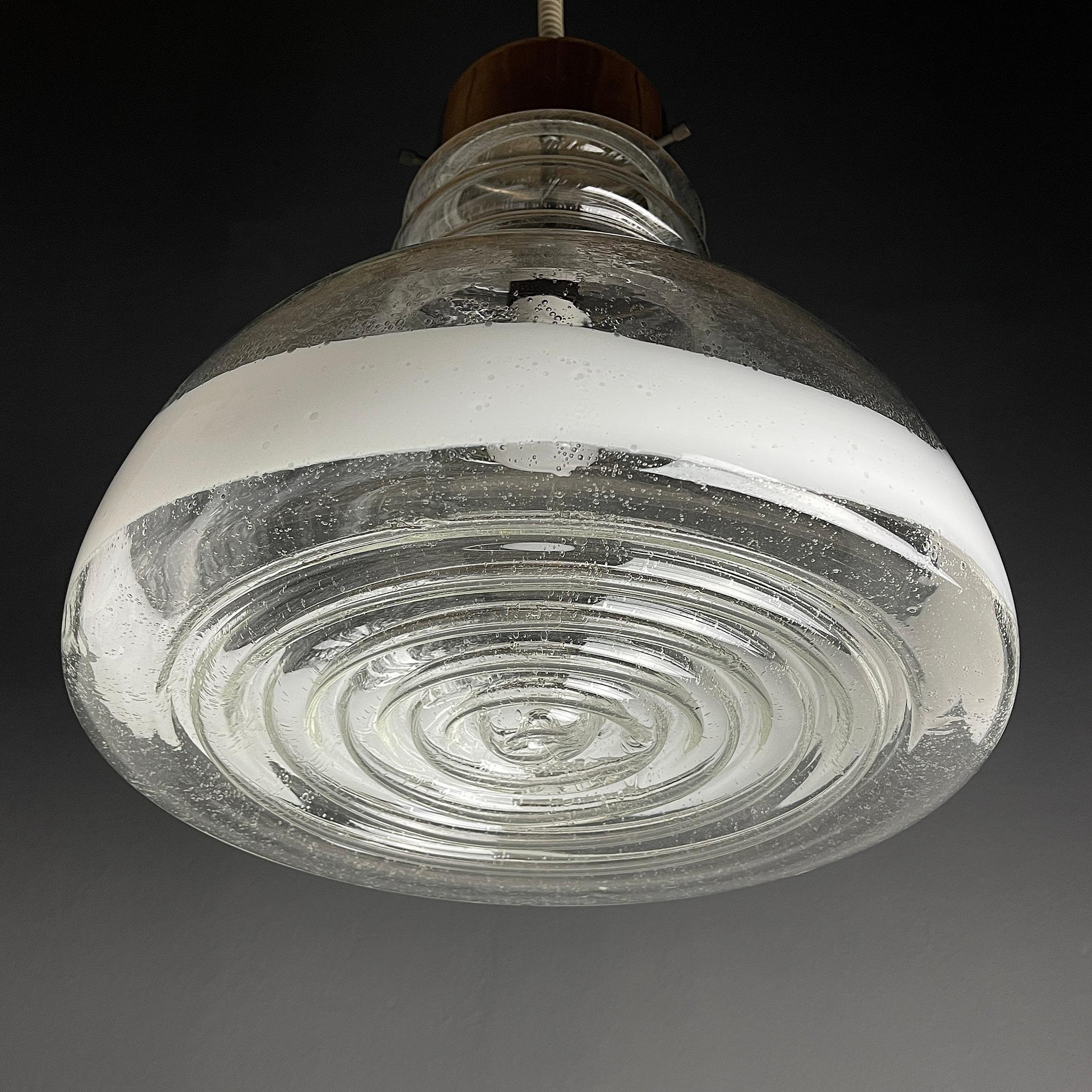 The rare large hand-blown Murano glass pendant lampa made in Italy in the 1960s. A transparent glass shade with a 