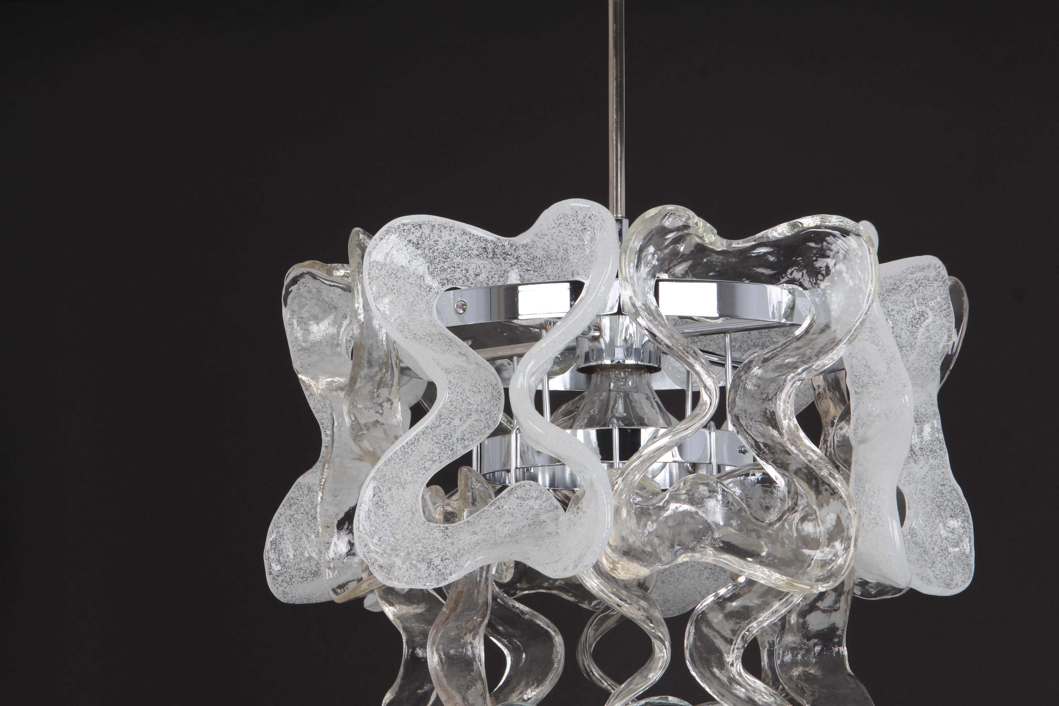 A stunning chrome pendant light with Murano glass elements designed by Carlo Nason for Kalmar, Austria, manufactured in 1960s. (Series: Catena)
The pendant is composed of 18 thick Murano textured ice glass elements attached to a chrome metal