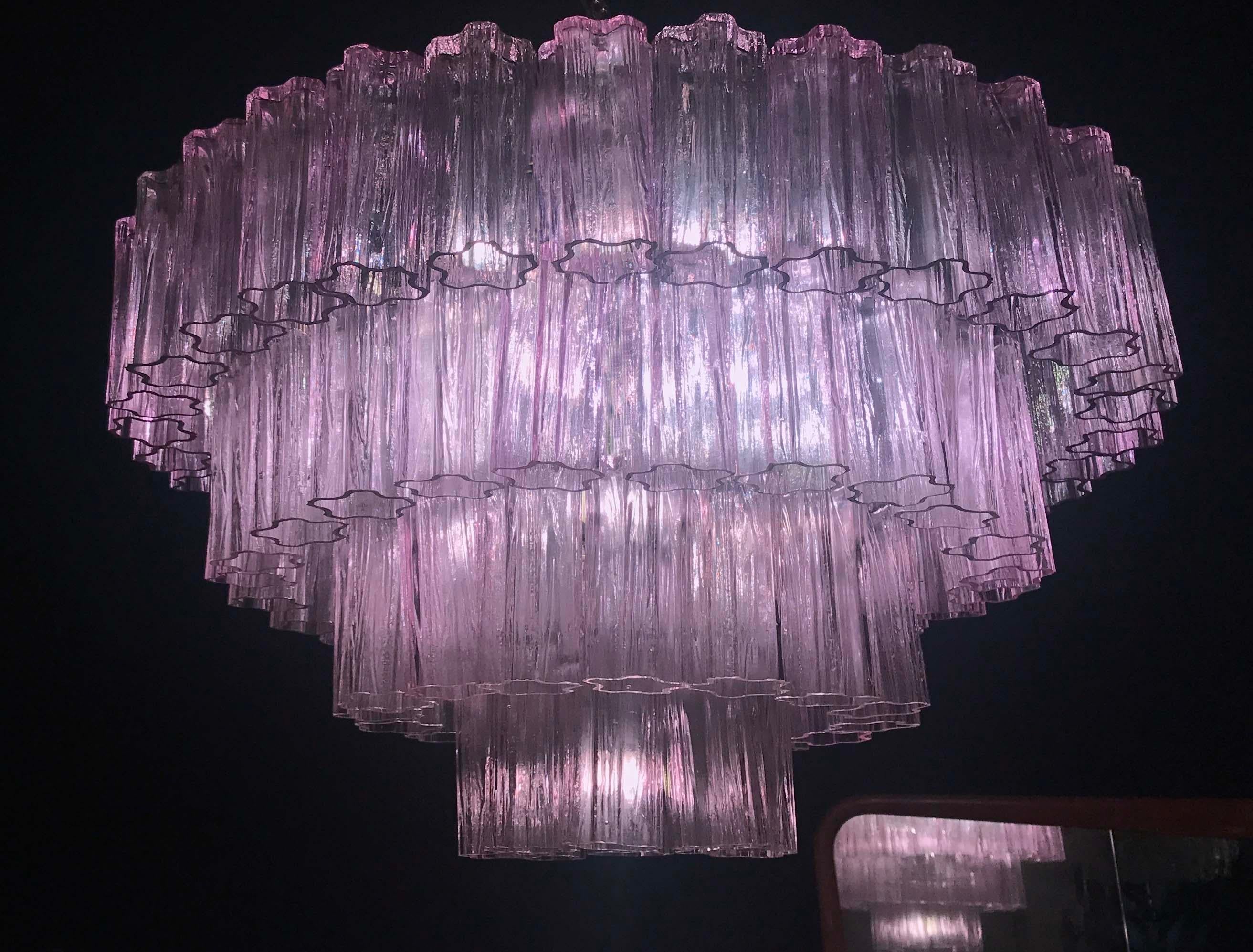 Fabulous chandelier with rare pink amethyst color precious Murano glasses.
Each chandelier with 80 glass blown elements supported by a chrome frame. Light off the glasses are fuchsia red. With a light on the color of the glasses turn in a magic