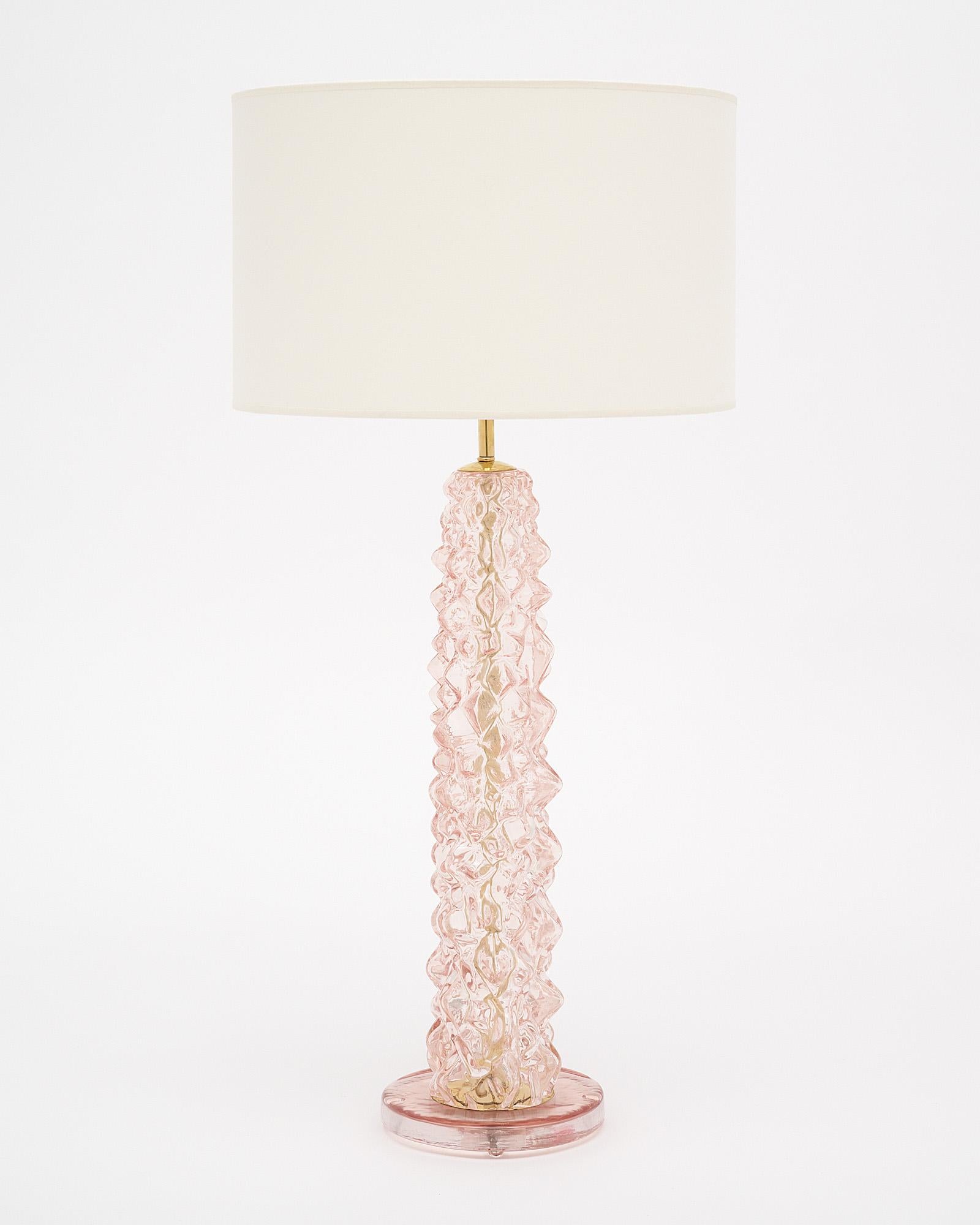 Pair of lamps made of hand-blown Murano glass in a lovely pink tone. This pair has been crafted in the “rostrate” technique in the manner of iconic Murano glass powerhouse “Barovier”, where the glass is pulled to mimic birds beaks. The glass is