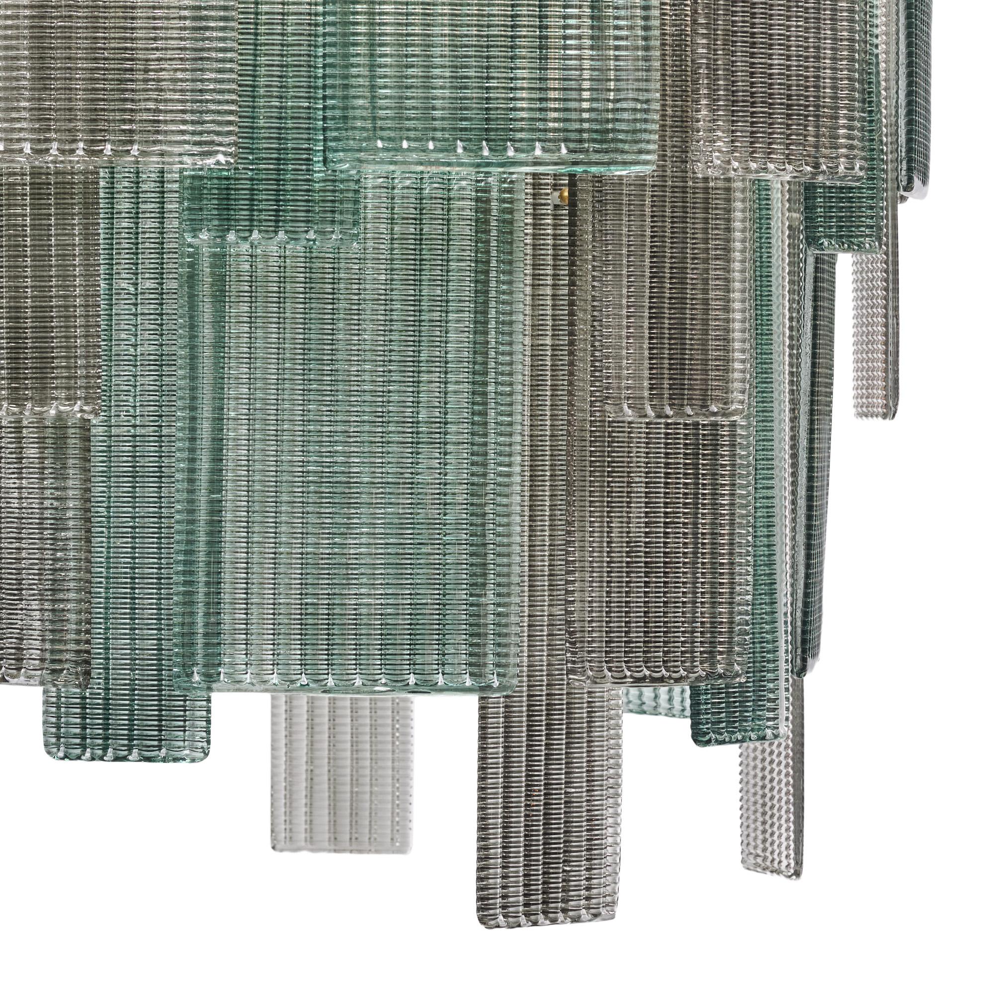 Murano glass chandelier from Murano outside of Venice, Italy. The hand-blown and molded glass has a woven texture to one side. The layered glass alternates between aqua and gray tones. It is supported by a brass structure. The fixture has been newly