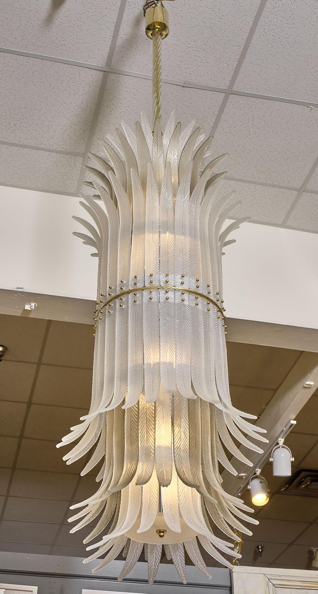 Murano glass chandelier made of multiple glass components or feathers attached to a circular structure. This piece has been newly wired to US standards.
Height from ceiling is 92.5