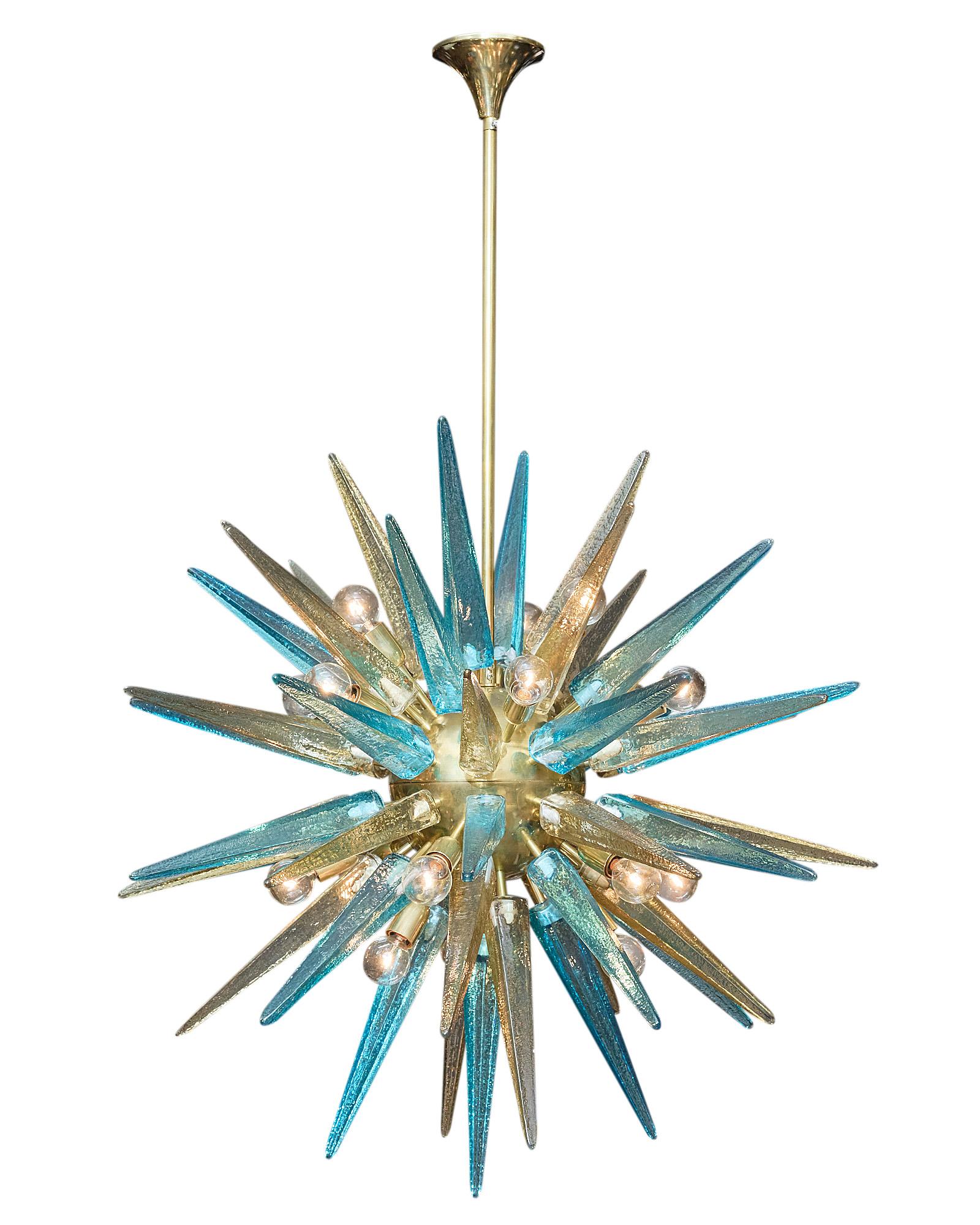Italian Murano glass sputnik chandelier with prism elements. This fixture features hand-blown glass prisms in amber and aqua blue tones mounted on a gilt brass structure. This spectacular chandelier has a stunning decorative impact! It has been