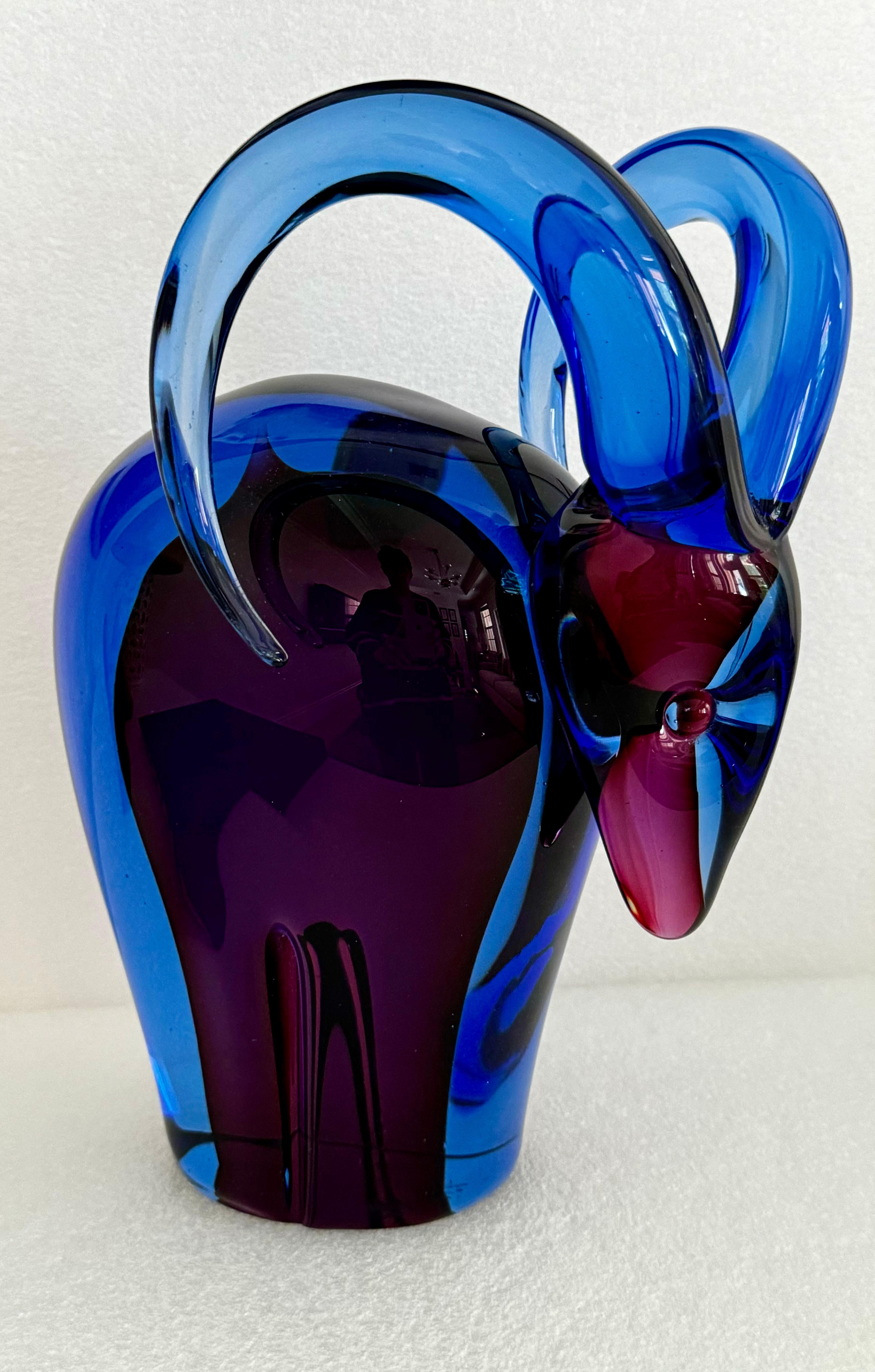 This exquisite Murano glass ram, attributed to the renowned designer Flavio Poli, embodies the elegance and artistry characteristic of mid-20th century Italian glasswork. Crafted with meticulous attention to detail, the ram features a stunning blend