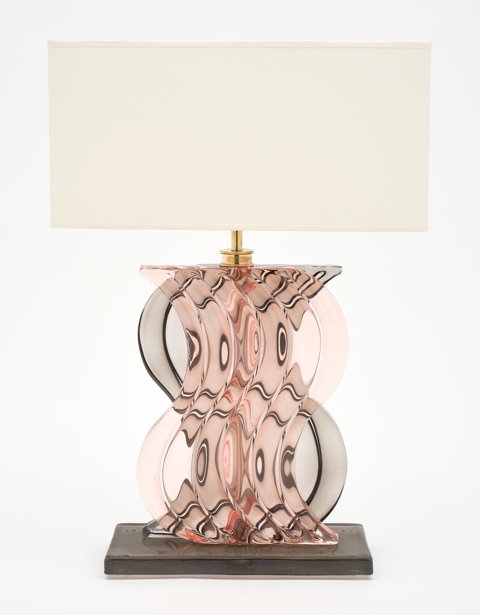 Murano glass ridged pink and gray lamps with beautiful curving glass elements layered for a striking effect. We love the contrast of the gray and powder pink hand blown translucent glass. They have been newly wired to fit US standards.

This pair is