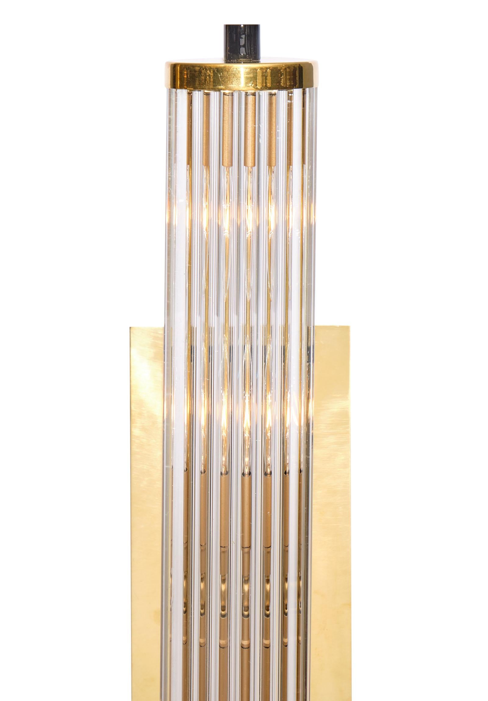 Brass and Murano glass rod sconces featuring multiple crystal clear glass rods hand blown by craftsman in Italy. They are held by a brass structure with black metal finials. We love the modernist style. They have been newly wired to fit US