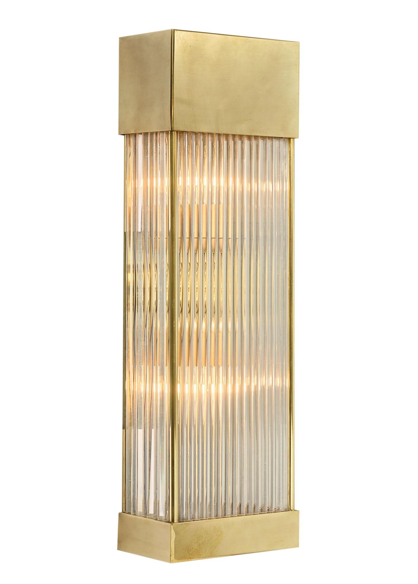 Pair of sconces from Murano, Italy featuring an array of glass rods maintained in bottom and top brass casings. This pair has been newly wired to fit US standards.

This pair is currently located at our dealer's warehouse in Italy. Please contact us