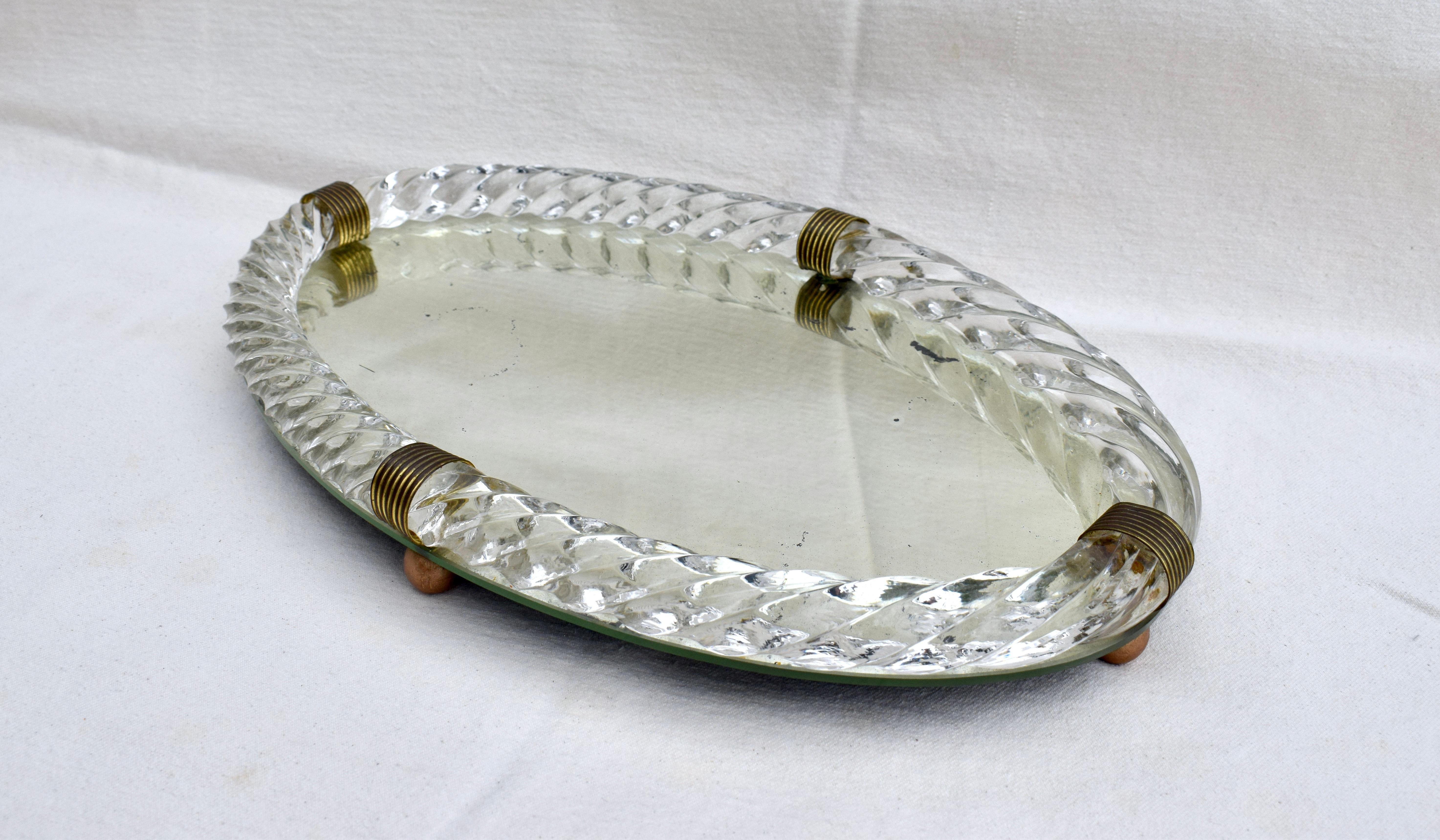 Exquisite Art Deco era mirrored footed tray with thick hand blown Murano glass gallery in the form of twisted rope. Oval in shape featuring four bronzed metal fittings.  Attributed to Barovier & Toso, in the style of Venini.