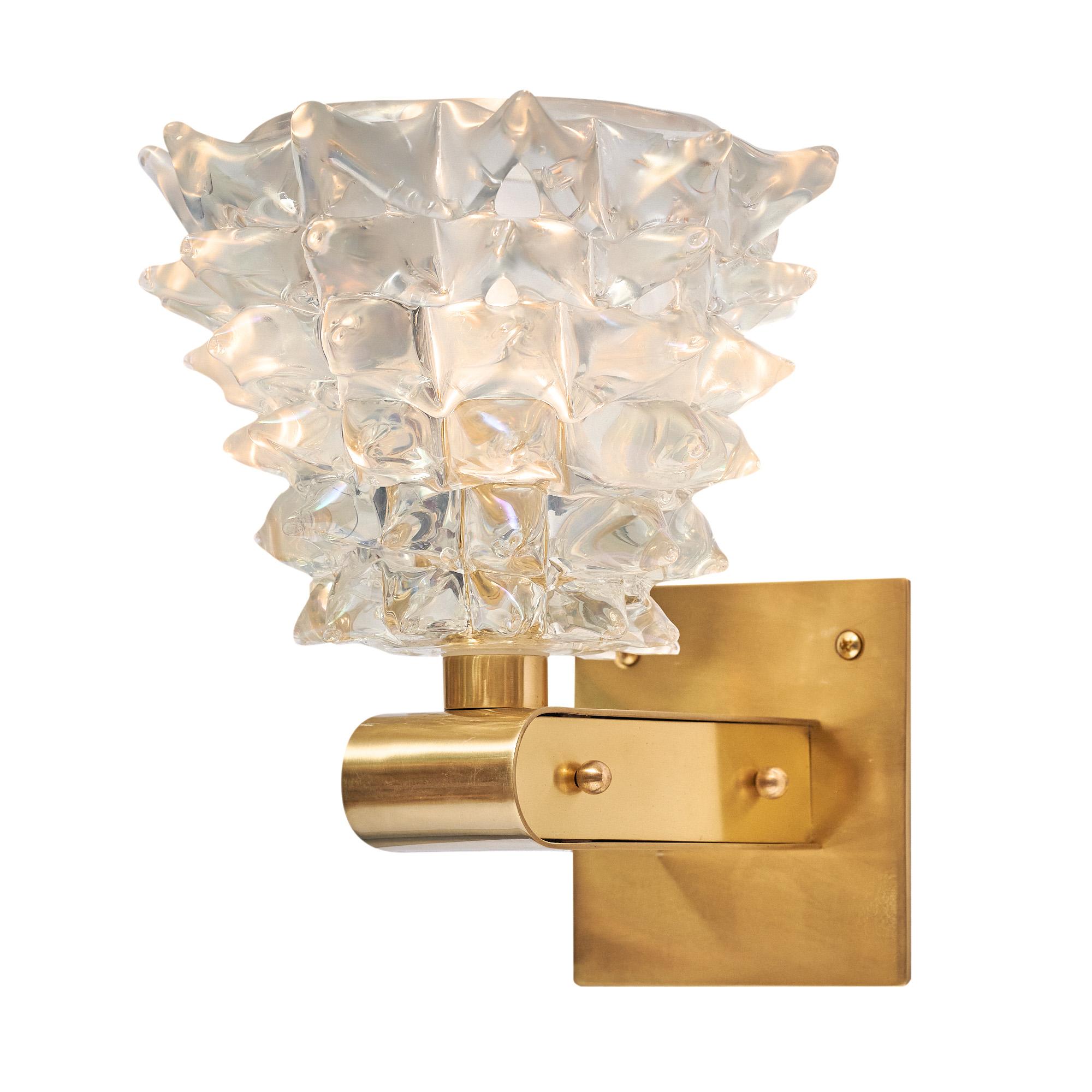 Pair of sconces from the island of Murano outside of Venice by iconic Venetian manufacturer Barovier. This pair features hand-blown and textured rostrate glass cups mounted on polished brass structures. The cups have a subtle yet eye-catching