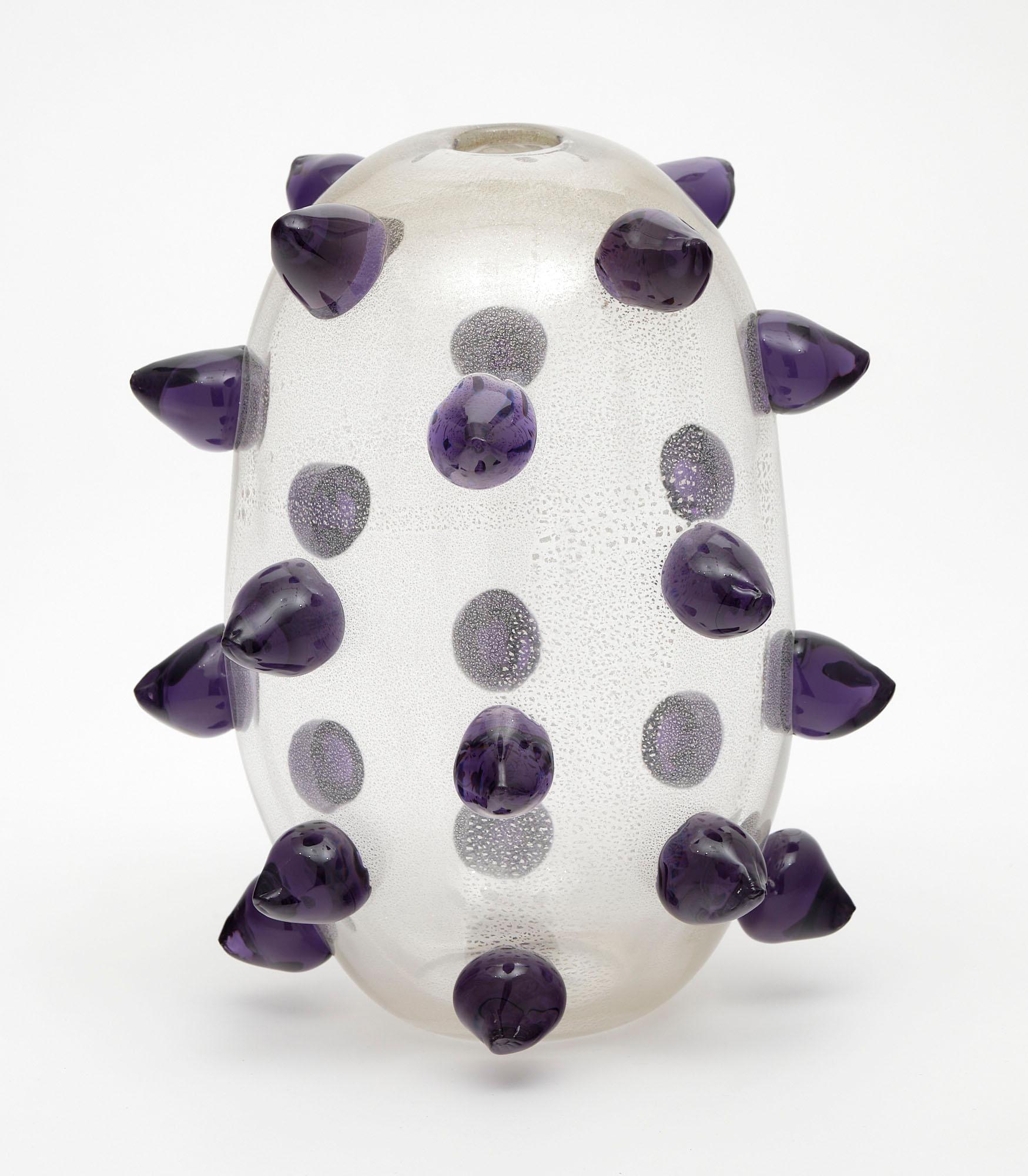 Vase of oval clear glass from the island of Murano featuring “beaks” (rostrate) of purple glass. We love this hand-blown unique piece.