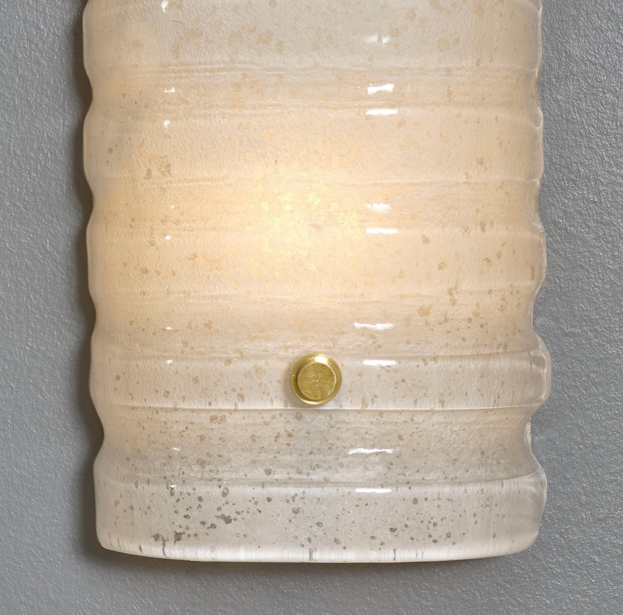 Murano glass pair of “scavo” sconces in an hand-blown ivory color. Each sconce was created using the 