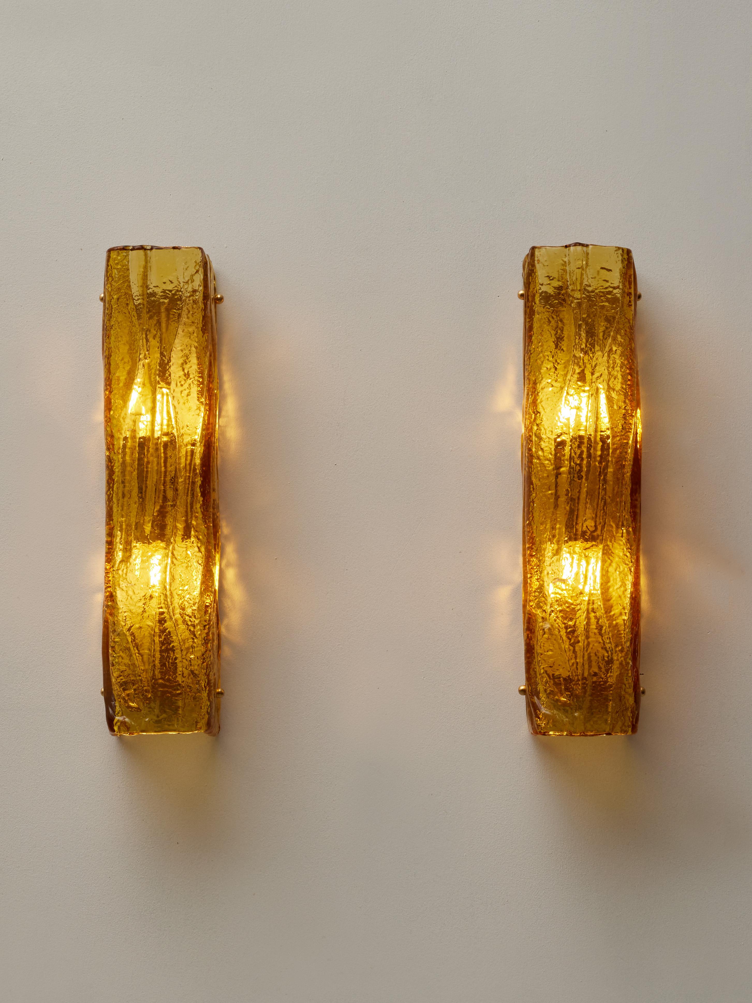 Splendid pair of sconces in sculpted and amber tainted Murano glass by Studio Glustin.