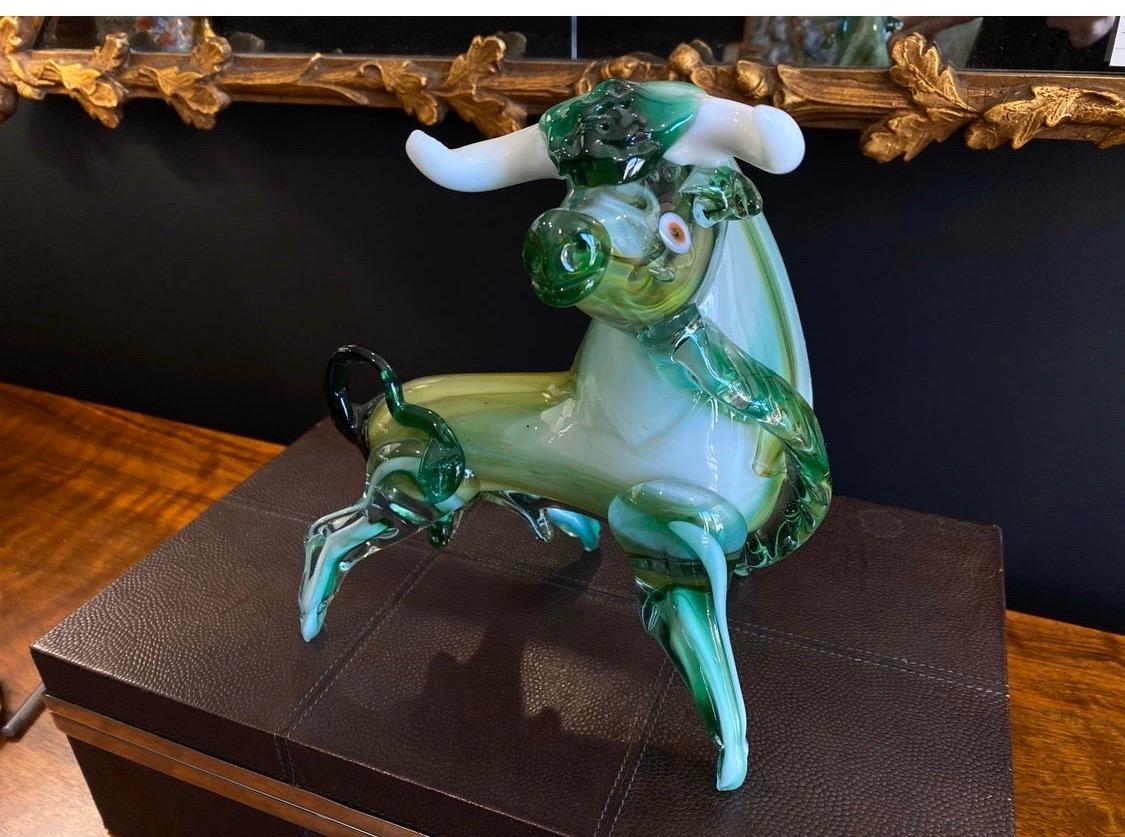 Prized Italian Mid-Century Modern sculpture of a bull done in Murano glass.
Features summers glass with tiny bubble technique in vibrant hues of greens,
white and yellow.