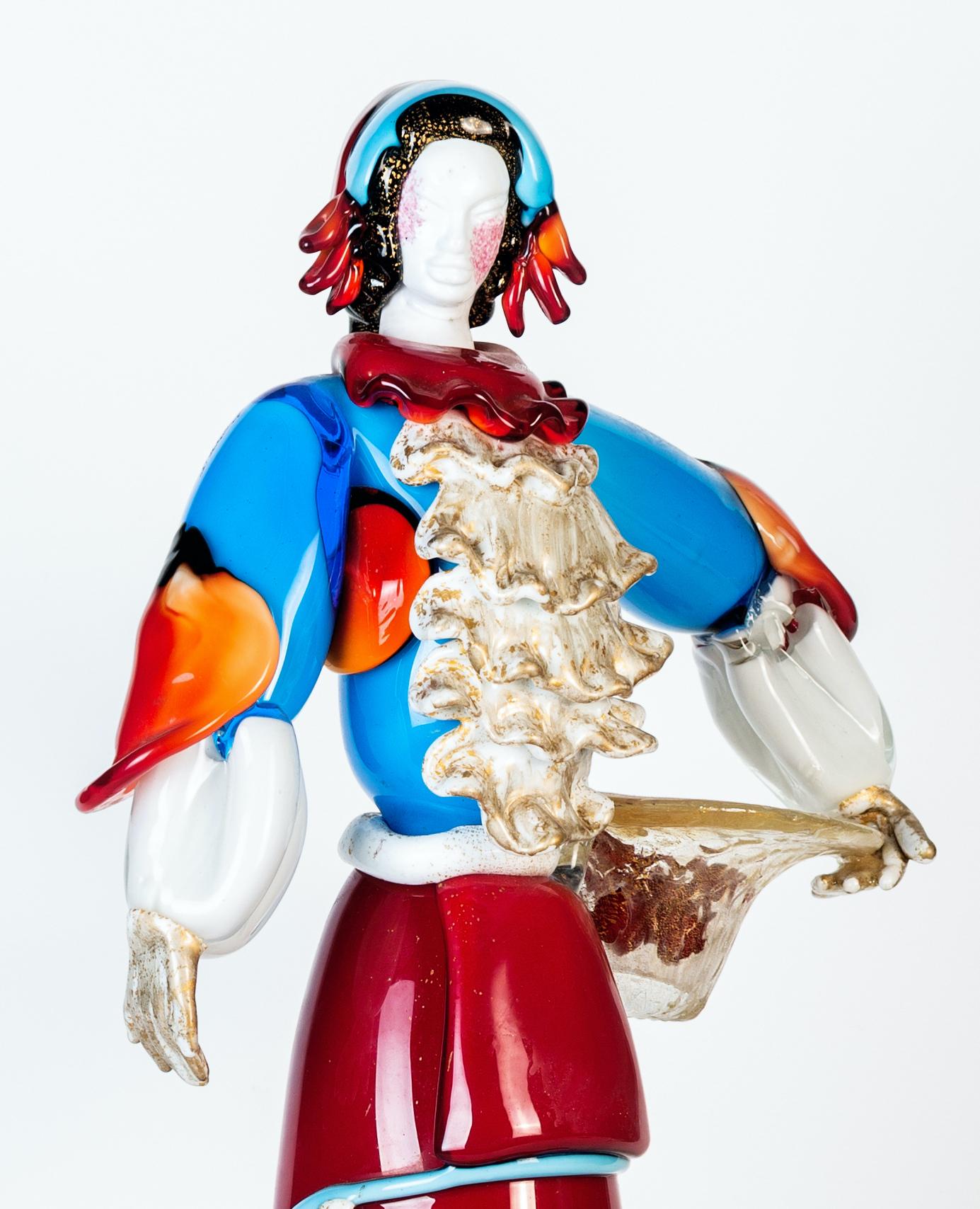 Murano glass woman is a beautiful glass decorative object, realized by Murano manufacture during the 1980s. 

This artwork represents a Venetian farmer with a basket under his arm. Good conditions.

Entirely handmade with the hot modeling