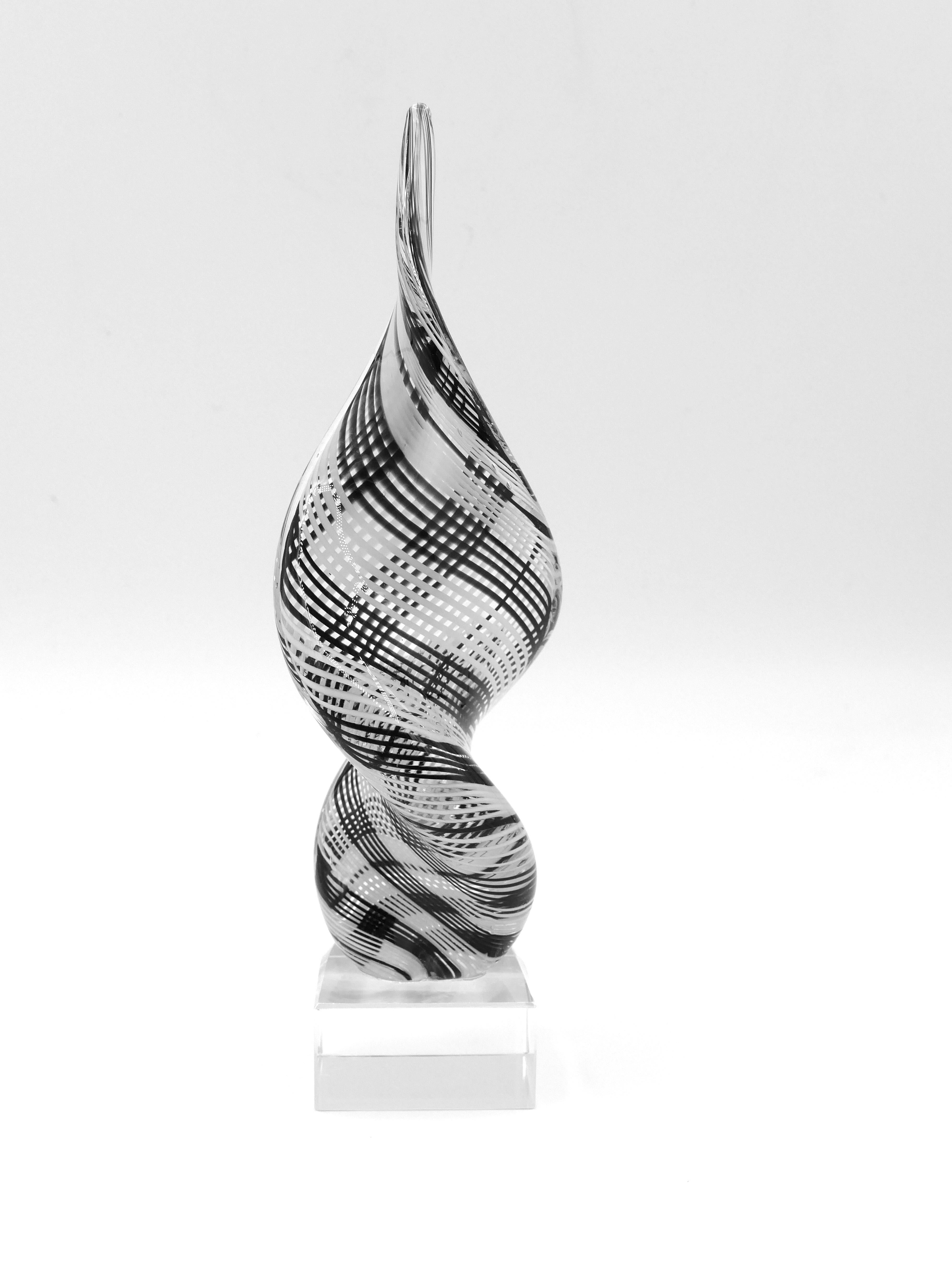 This Murano glass sculpture is a splendid decorative object manufactured by the Italian company Salviati. 

Murano colorless glass standing on a square base.

The surface is crossed by sinuous fine white and violet lines. 

Dimensions: cm 27