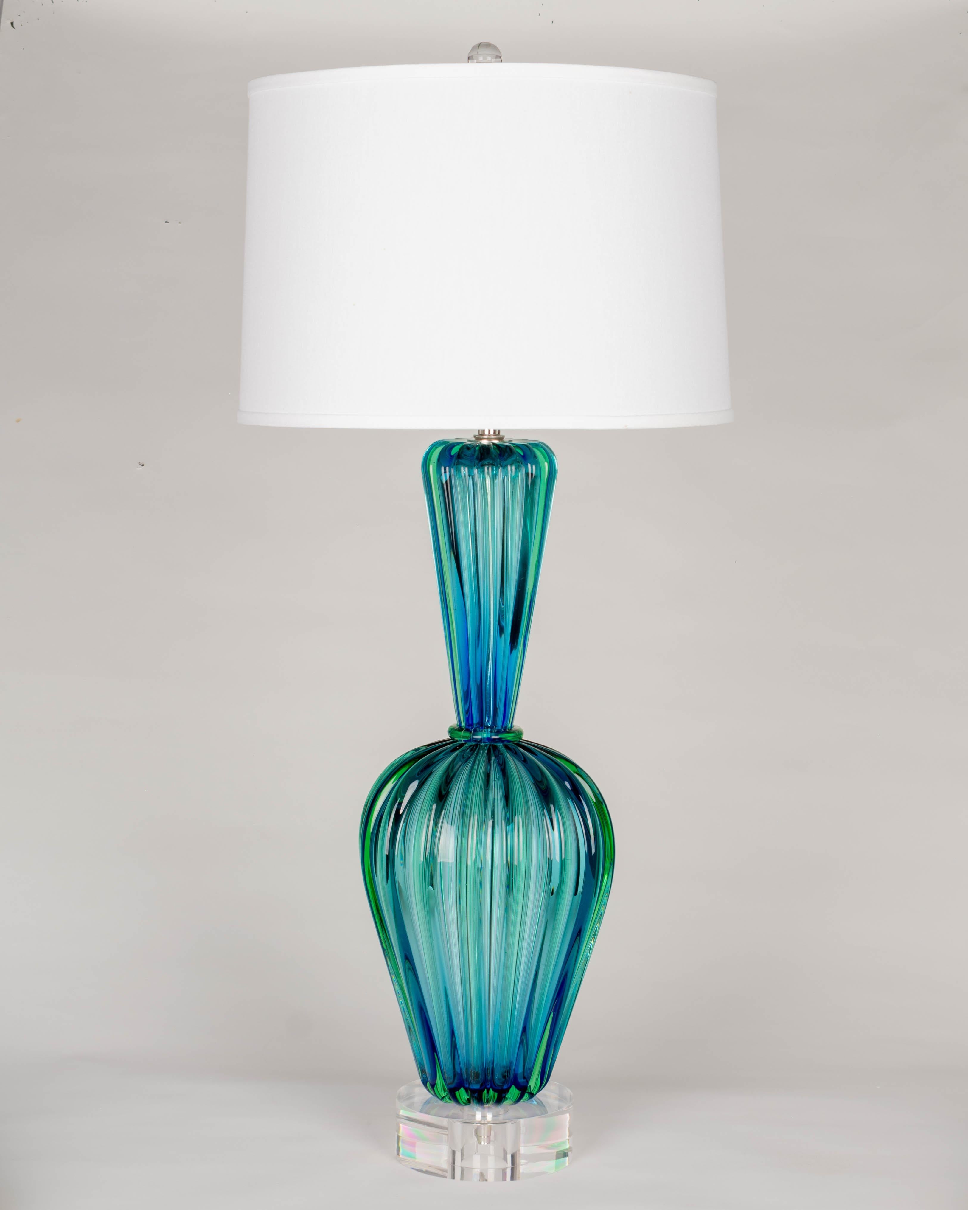 A large Murano glass lamp by Seguso, in two parts with heavy, thick hand-blown blue and green sommerso ribbed glass. Stunning color and clarity. New lucite base and glass finial. Rewired with new socket. Weight: 16.7 Lbs.
37