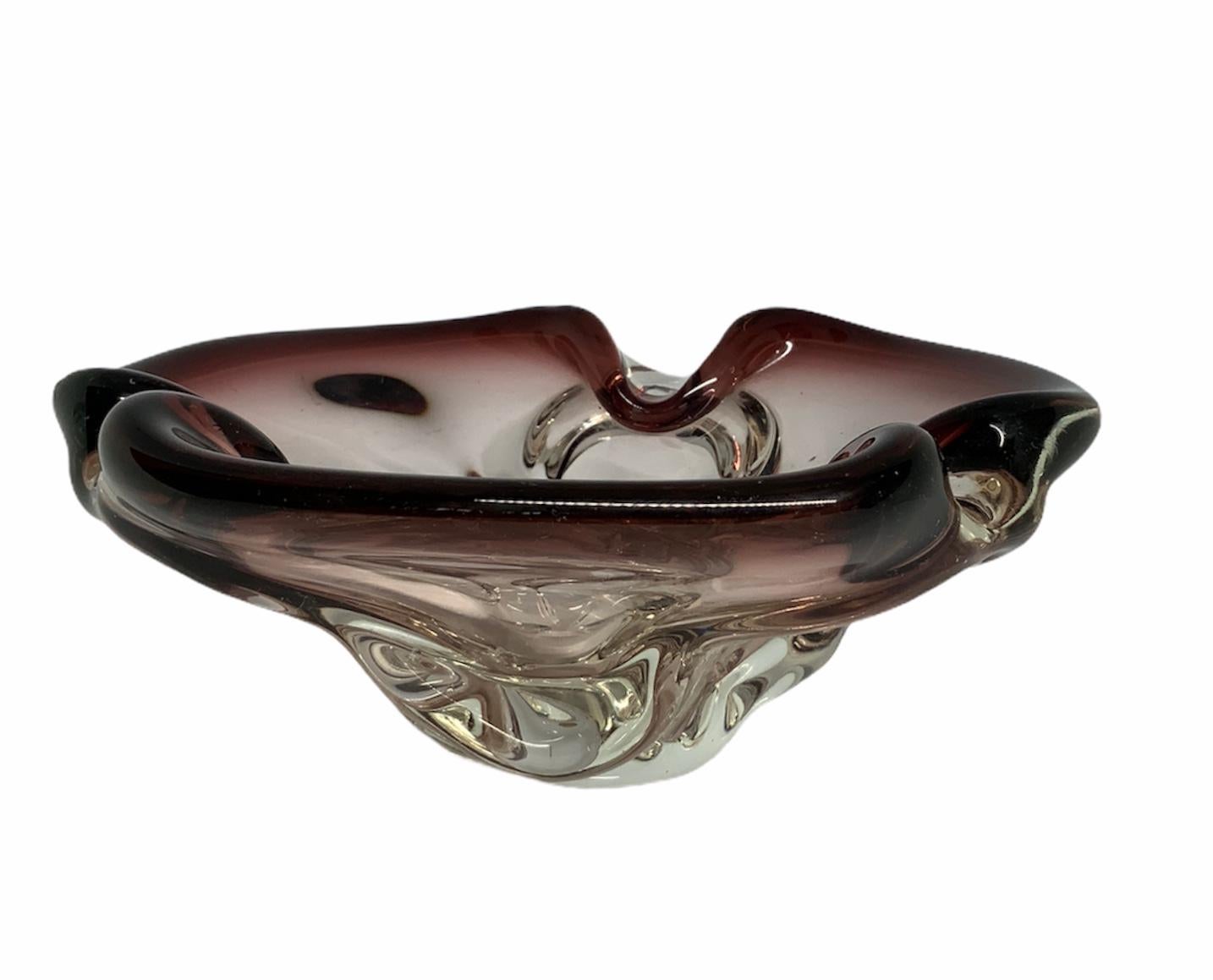 This is a shamrock shaped purple glass folded rim bowl.
