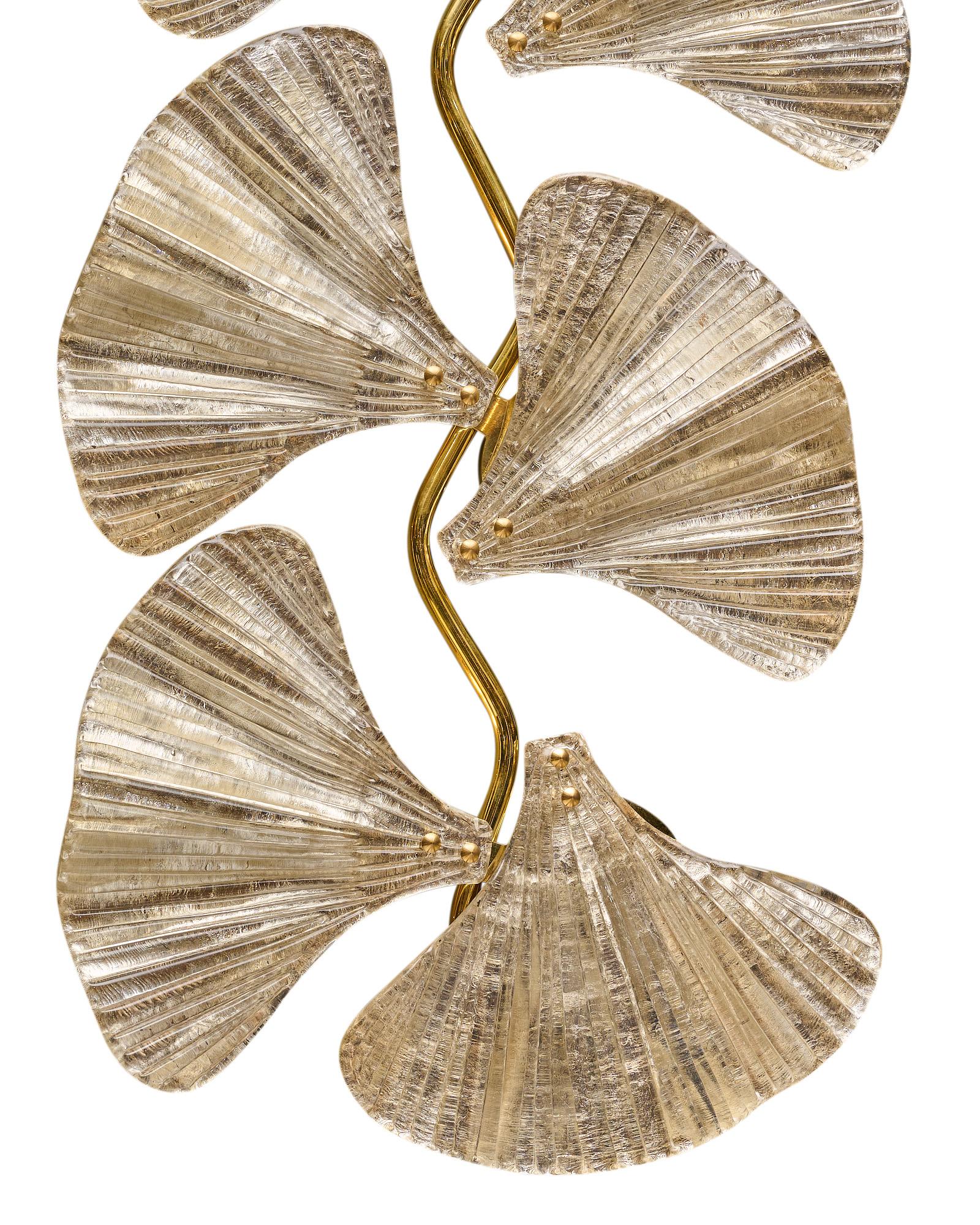Pair of sconces, Italian, from the island of Murano. This pair is made of hand-blown glass with silver leaf in the delicate shape of ginkgo leaves. They are supported on a brass structure. Newly wired to fit US standards.