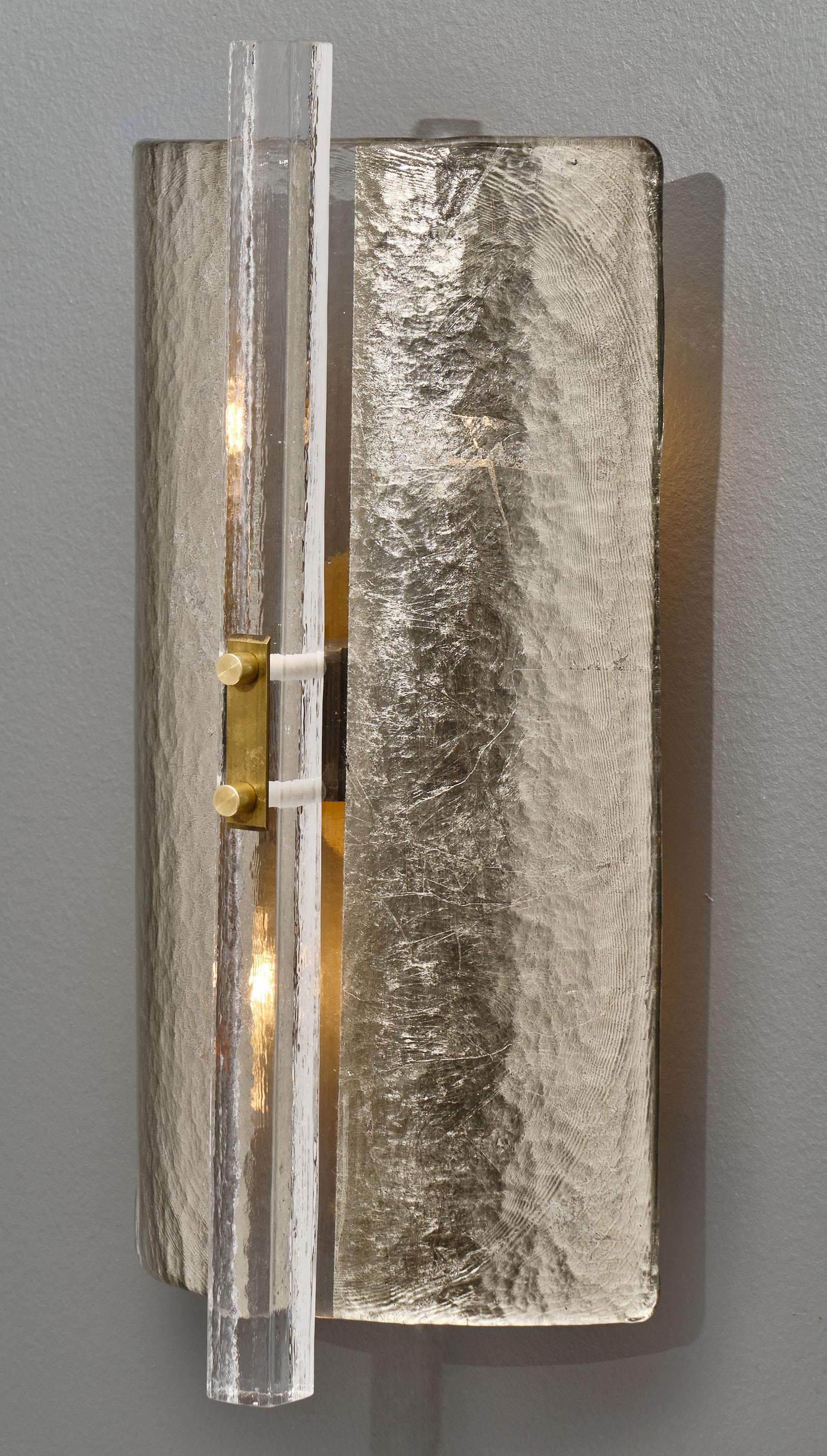 Silver leaf murano glass sconces from Italy with thick textured glass lined with silver leaf and featuring a rectangle glass rod held in place by brass hardware. This pair has been newly wired to fit US standards.

This pair is currently located