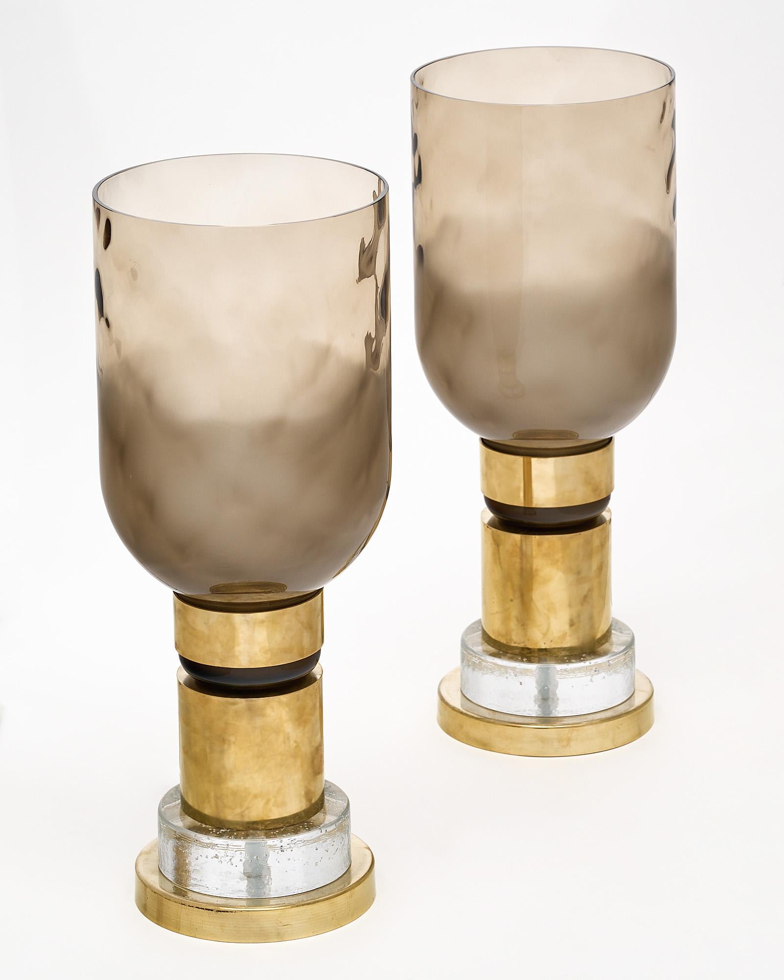 Pair of lamps, of Murano glass, crafted on the island of Murano next to Venice. The important lamps feature a smoked and textured shade in an organic “hammered” fashion, while the base boasts brass cylindrical components and clear textured glass in
