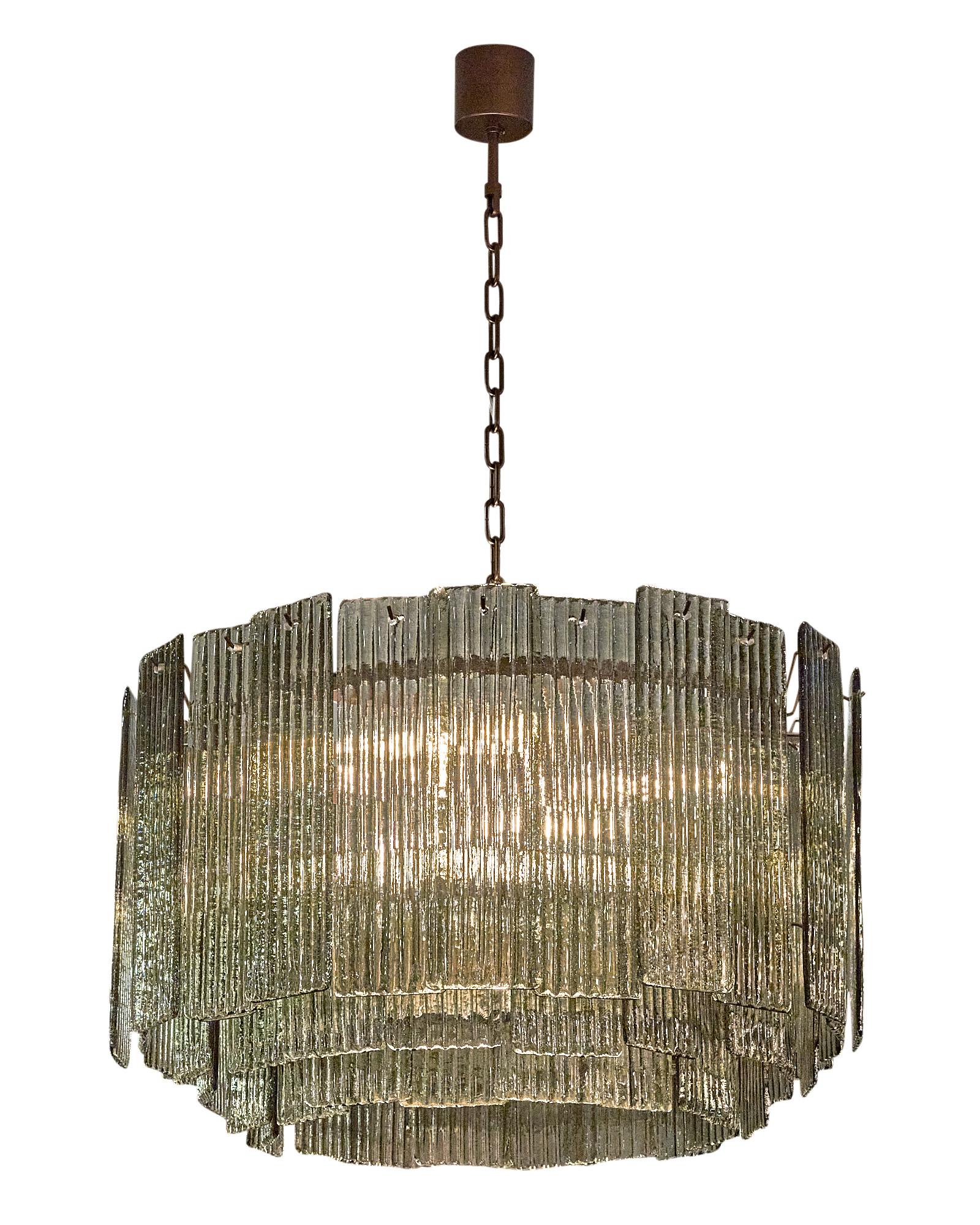Murano Glass “a piastre” chandelier by Alberto Dona. This piece is a stunning; bold fixture with an array of overlapping plates of hand-blown and molded Murano glass. The textured glass elements are in a beautiful smoked shade of gray and hang on a
