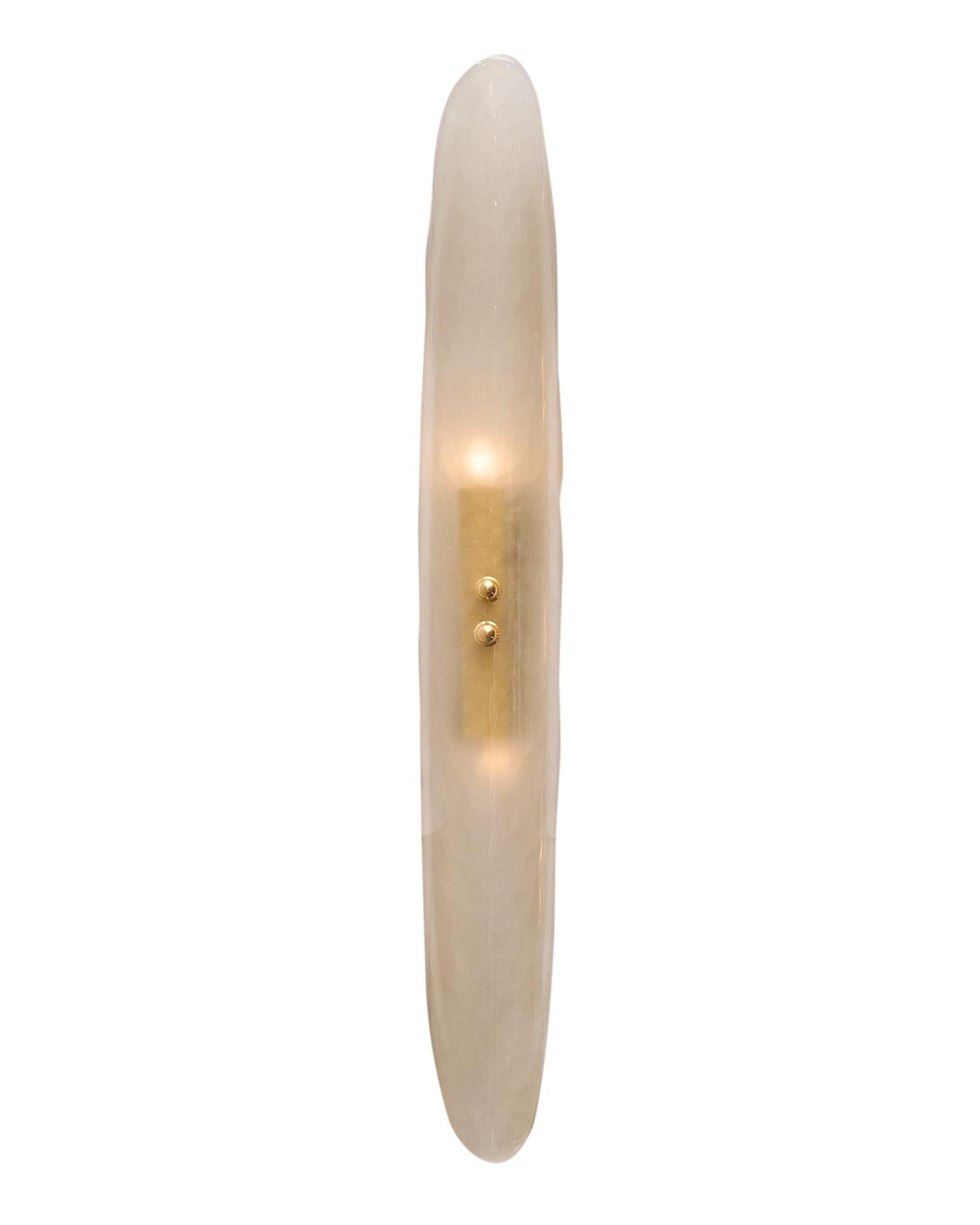 Pair of Murano glass sconces, each crafted with a single curved panel of hand-blown smoked glass on a brass frame. We love the modern style and hand-crafted quality of these sconces. They have been newly wired to fit US standards.
This pair is a