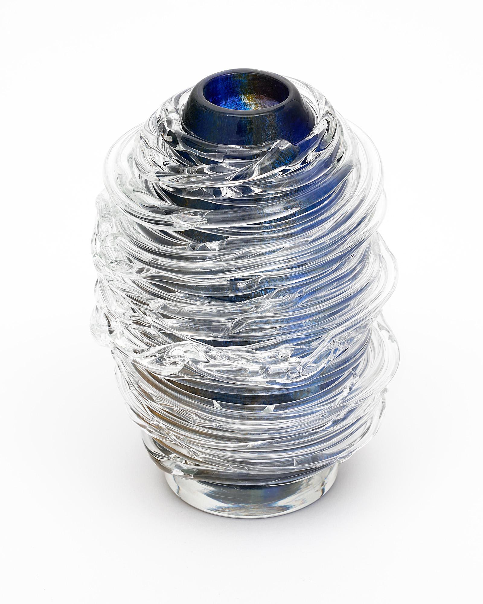 Vase from Murano, Italy. Hand-blown, the transparent glass still in fusion was wrapped around the dark blue main body of the vase. It is a unique piece with movement.
