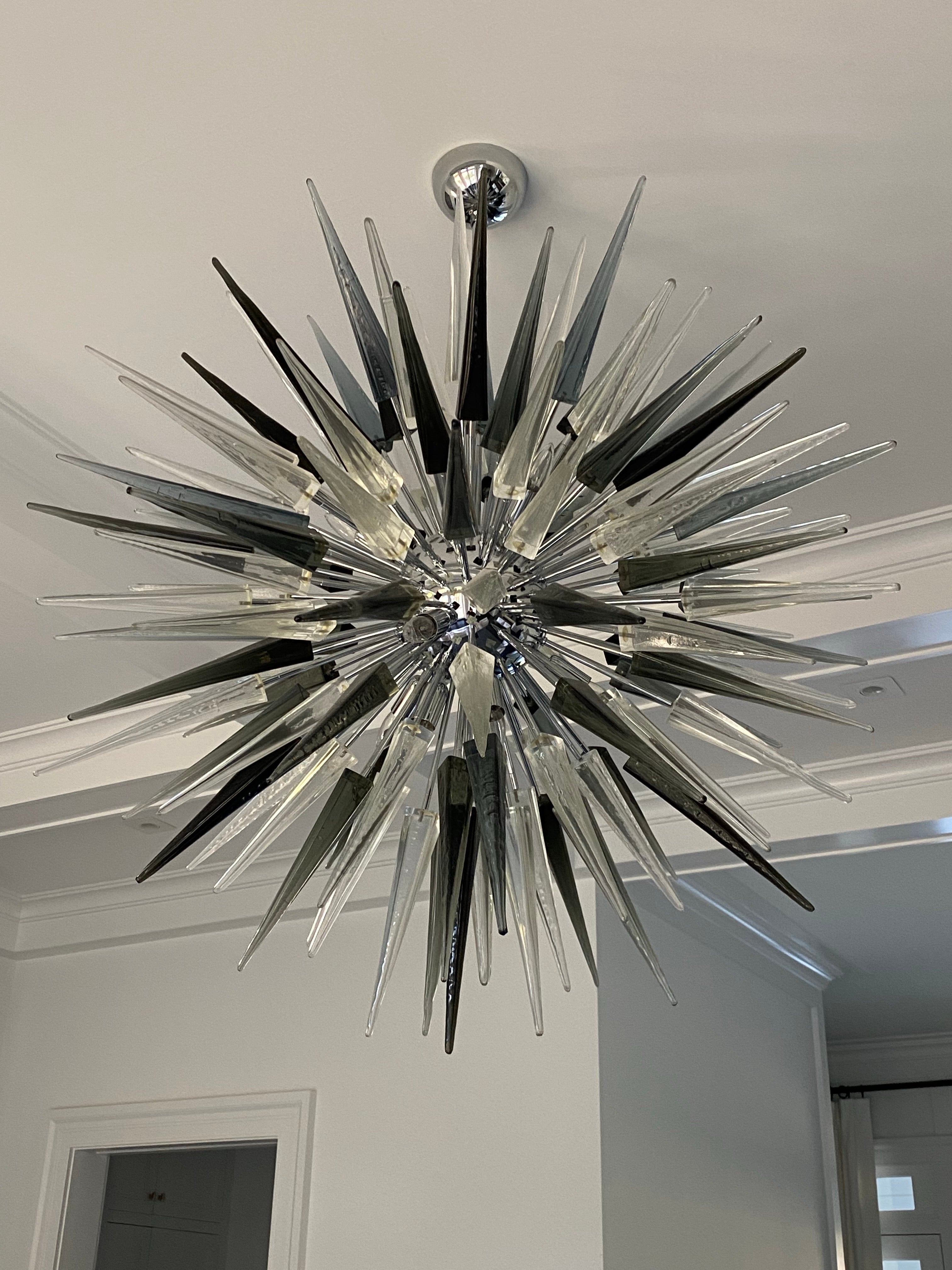 Italian Handmade Murano Glass Sputnik Chandelier. Frame & stems made of chrome, with handmade blown transparent and black Murano glass in the form of ice icicles. 12 bulbs. 

Condition: Very good condition. Wear consistent with age and use.
45'' D x