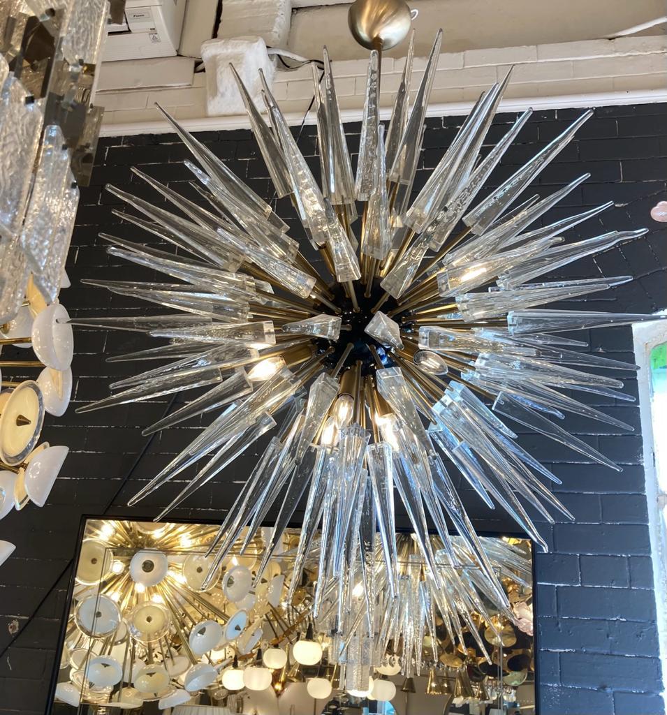 Italian spiked glass sputnik chandelier with black lacquered centre sphere brass finish. circa 1970s.