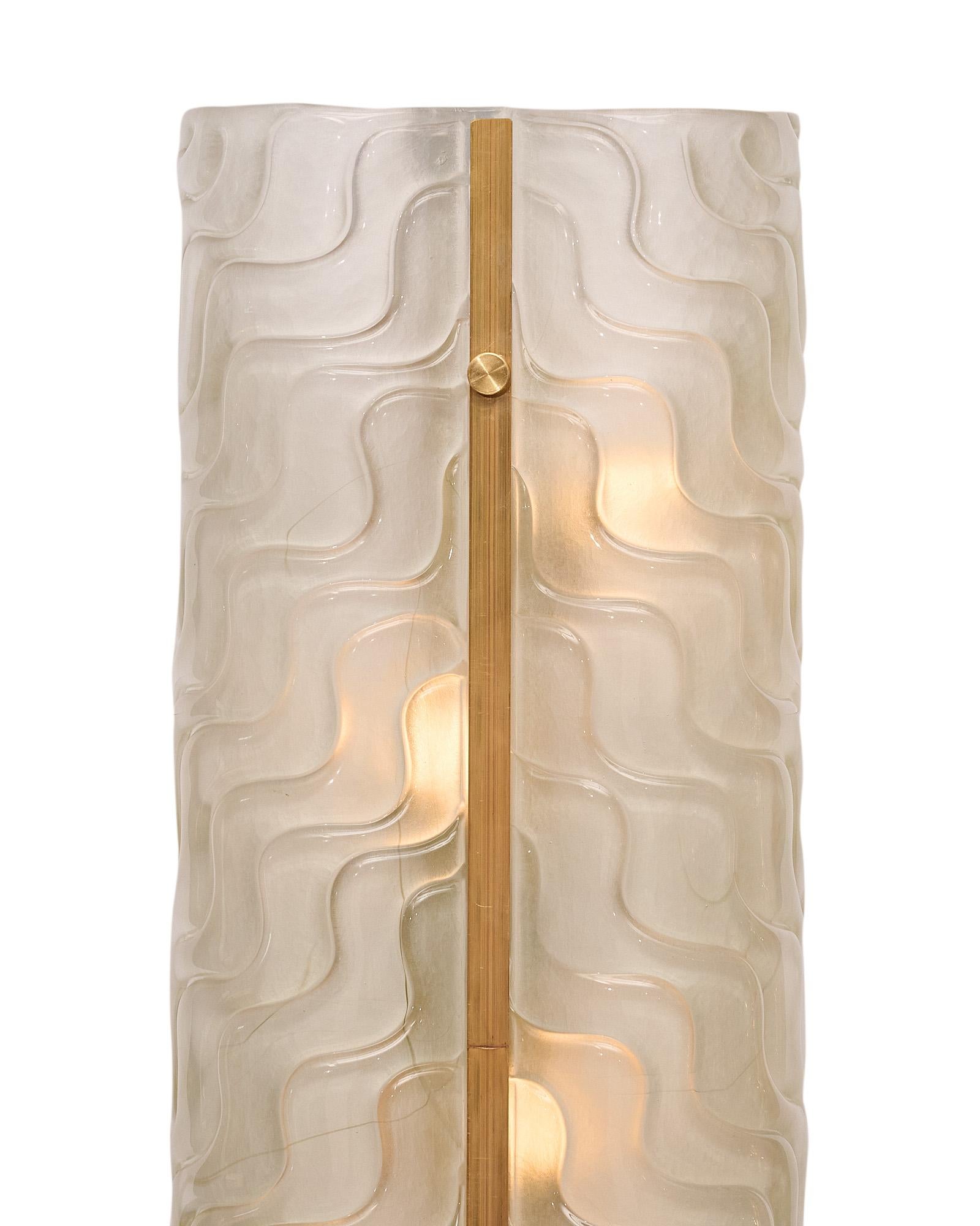 Pair of sconces made of hand-blown Murano glass with a stamped pattern and brass trim. This pair has been newly wired to fit US standards.