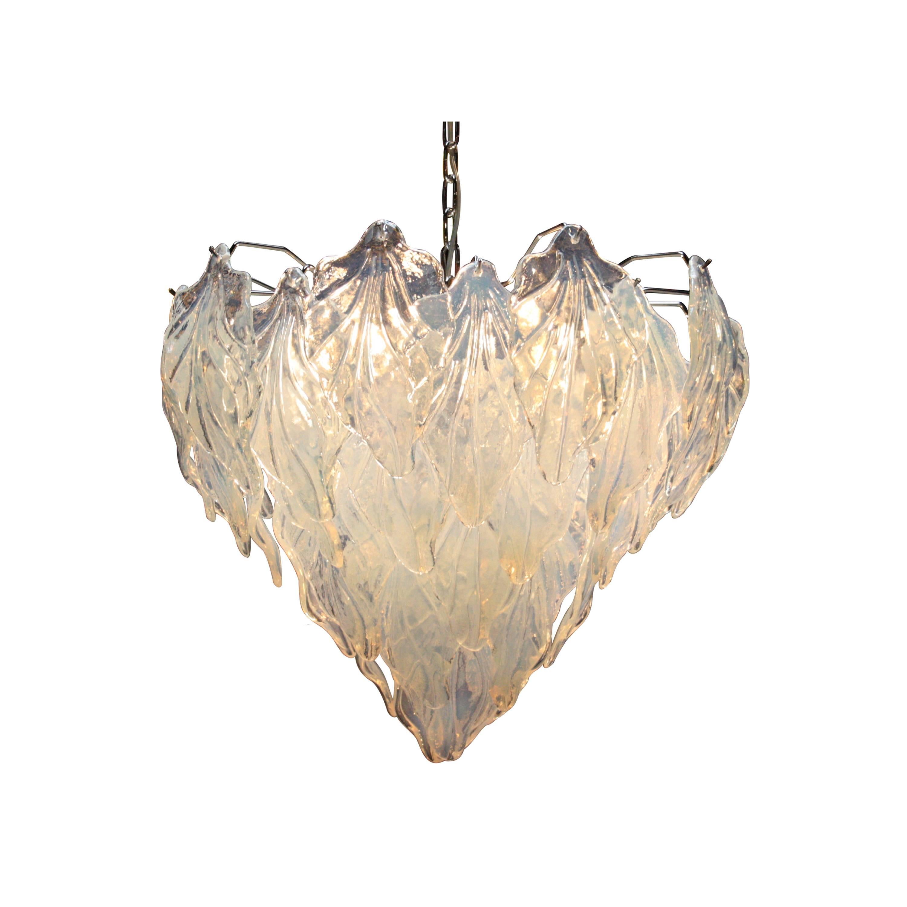 Suspension lamp composed of four points of light with metal structure. Vegetable decoration in Murano glass carved and molded by hand in white with iridescent finish.