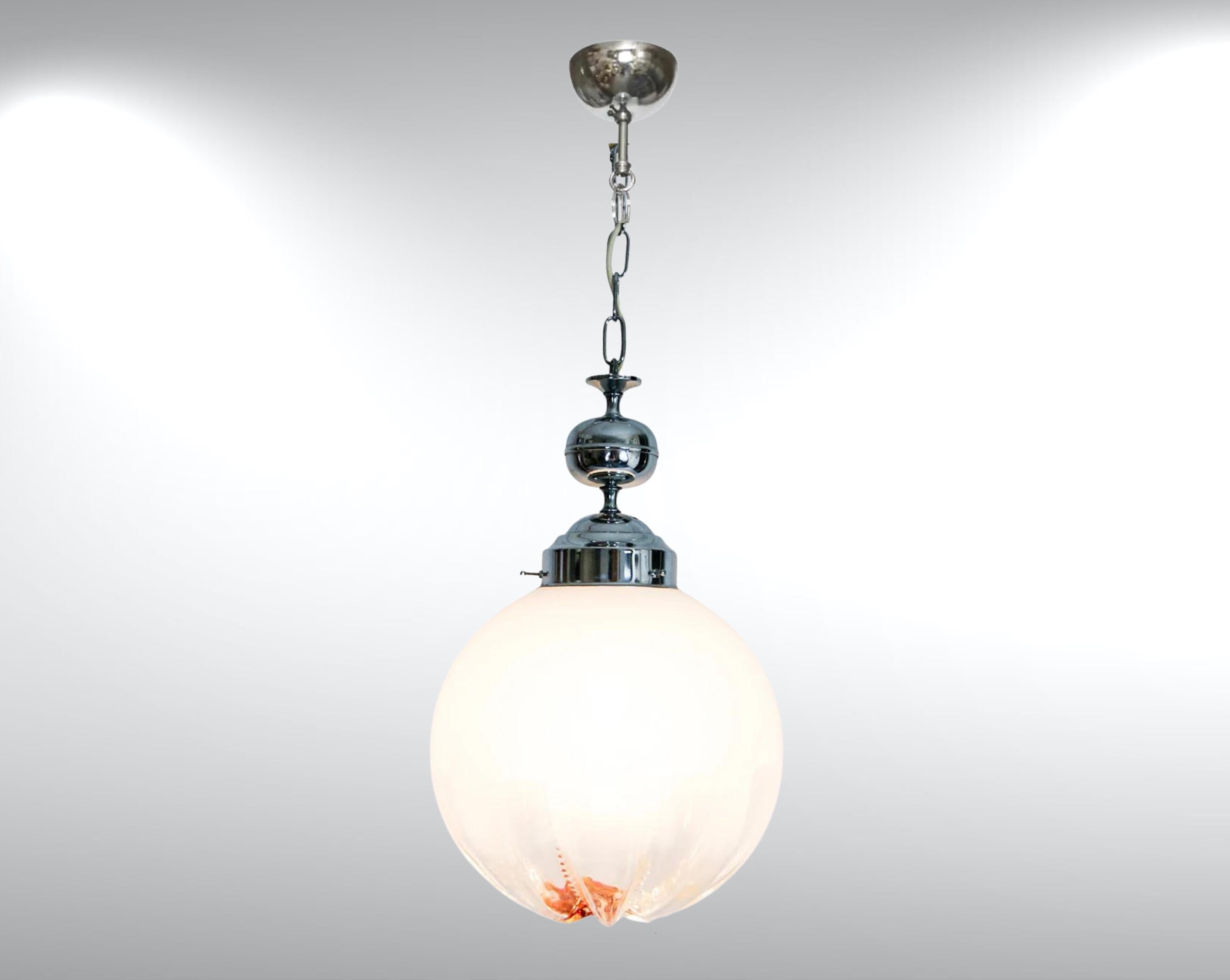 Lampe suspendue en verre de Murano par Mazzega, circa 1960s.
Attribué à Toni Zuccheri.
Diffuseur globe en verre sommerso de grande taille. 
La coloration va d'un dégradé de blanc laiteux à un verre clair vers la base, puis à un éclat intense d'ambre
