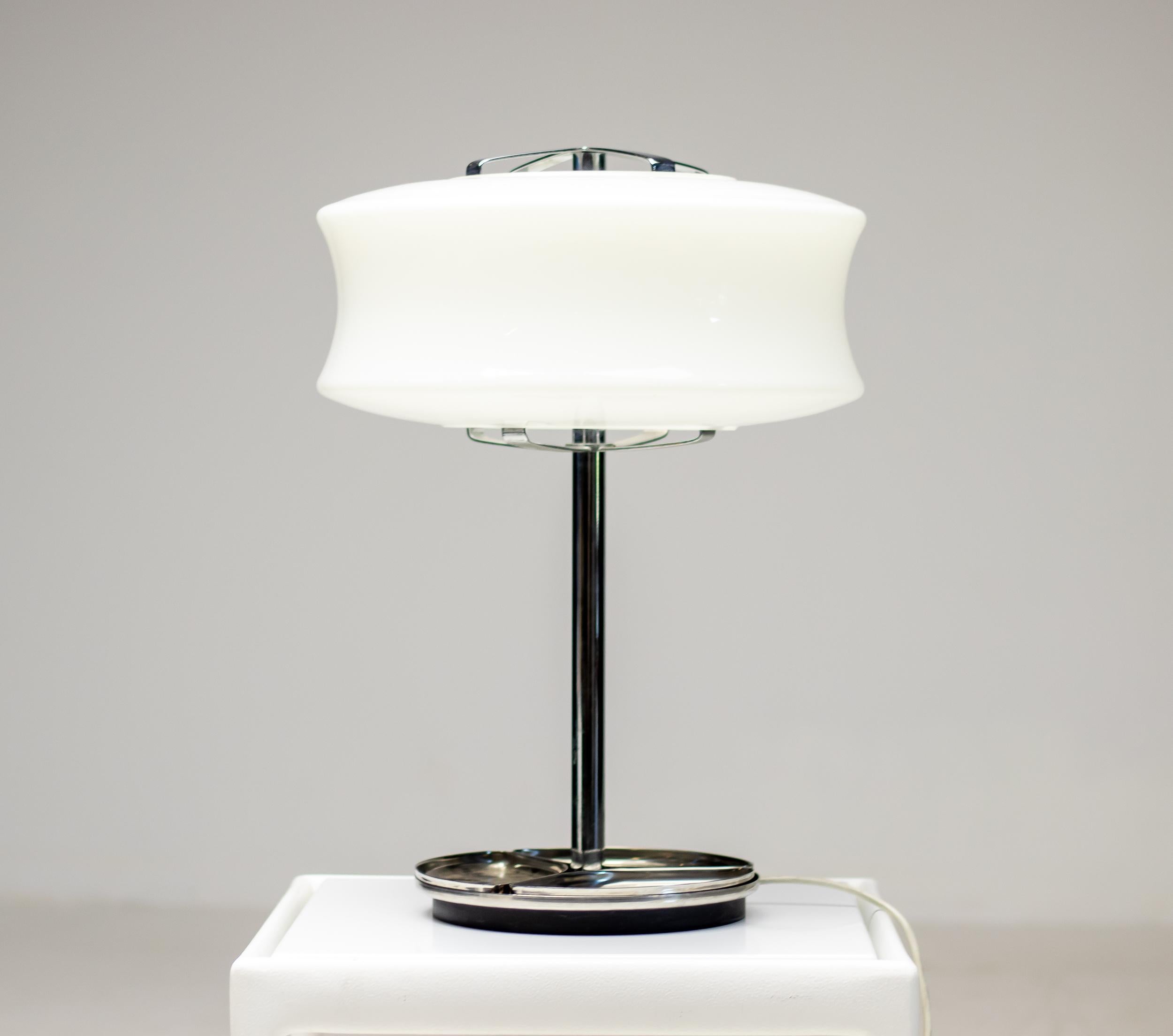 Wonderful large desk lamp lamp made circa 1960 by Valenti, Milano, Italy.
The lamp has a stainless steel frame with three removable trays on the base, and a glossy, opalescent glass lampshade. 
The light is equipped with a solid cast iron disc under