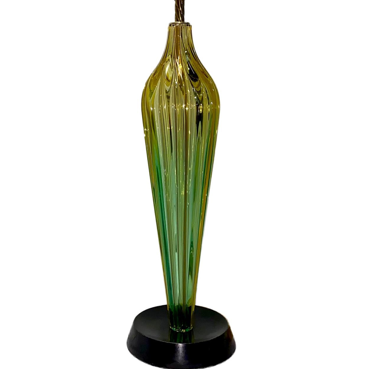 A circa 1920 Murano glass table lamp with wooden base.

Measurements:
Height of body: 23