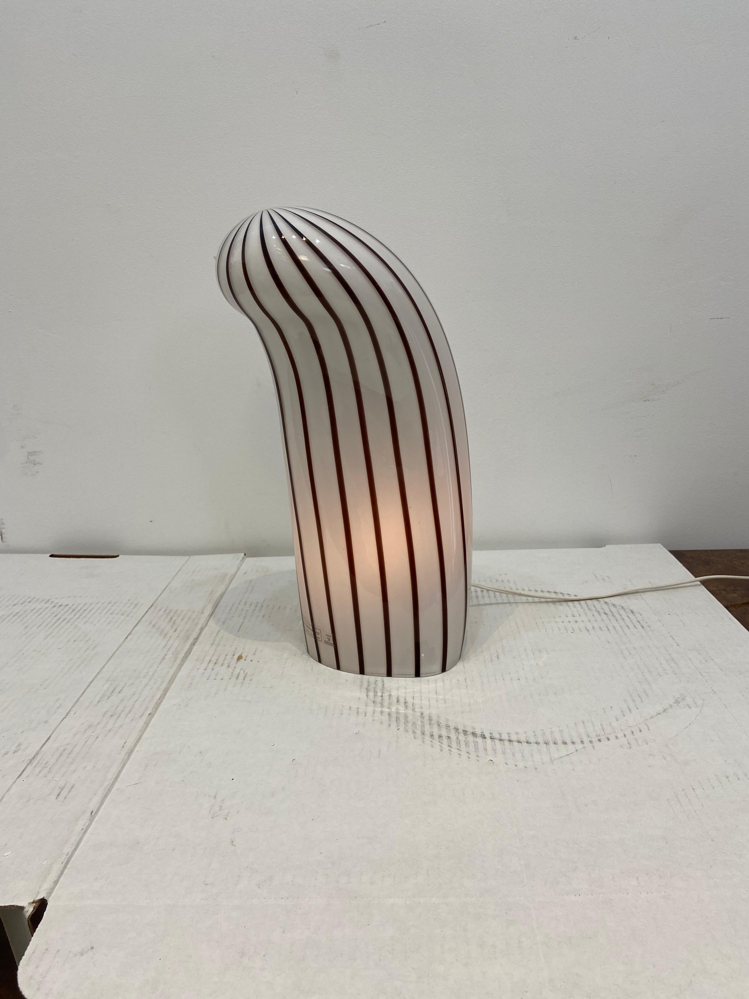 Murano glass table lamp with striped purple design curved glass in very good condition no damage. 15 inches tall.