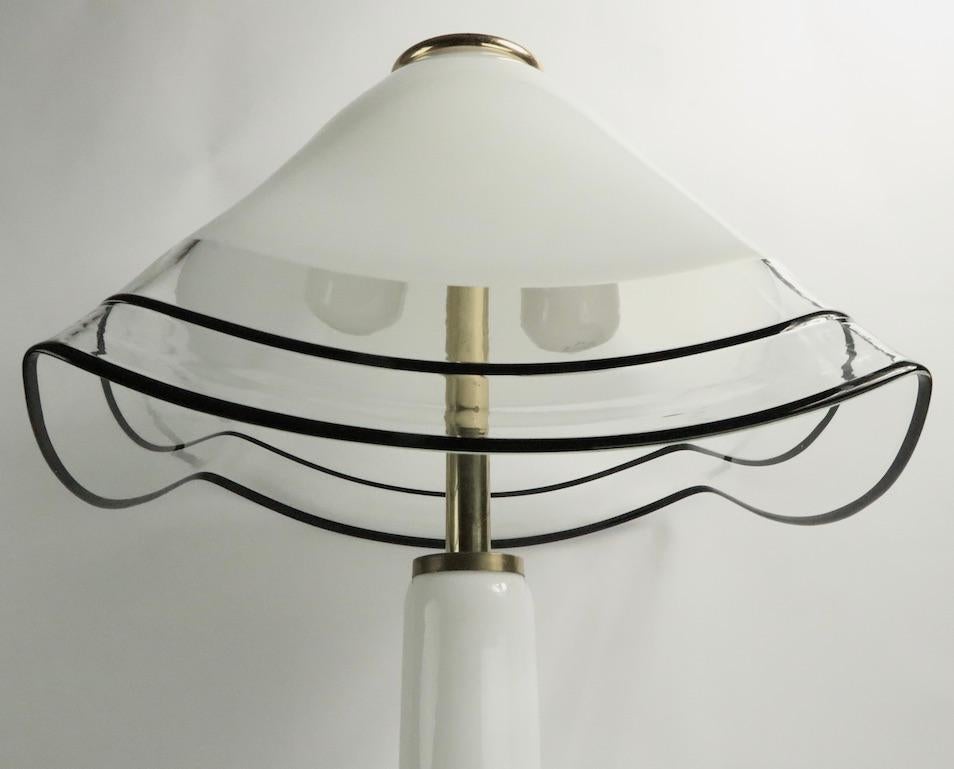 Stunning modernist Murano table lamp with glass base and shade, attributed to Lino Tagliapietra for Effetre International. Glass handkerchief form shade rests on elegant tapered glass base.This impressive lamp is in excellent original, working