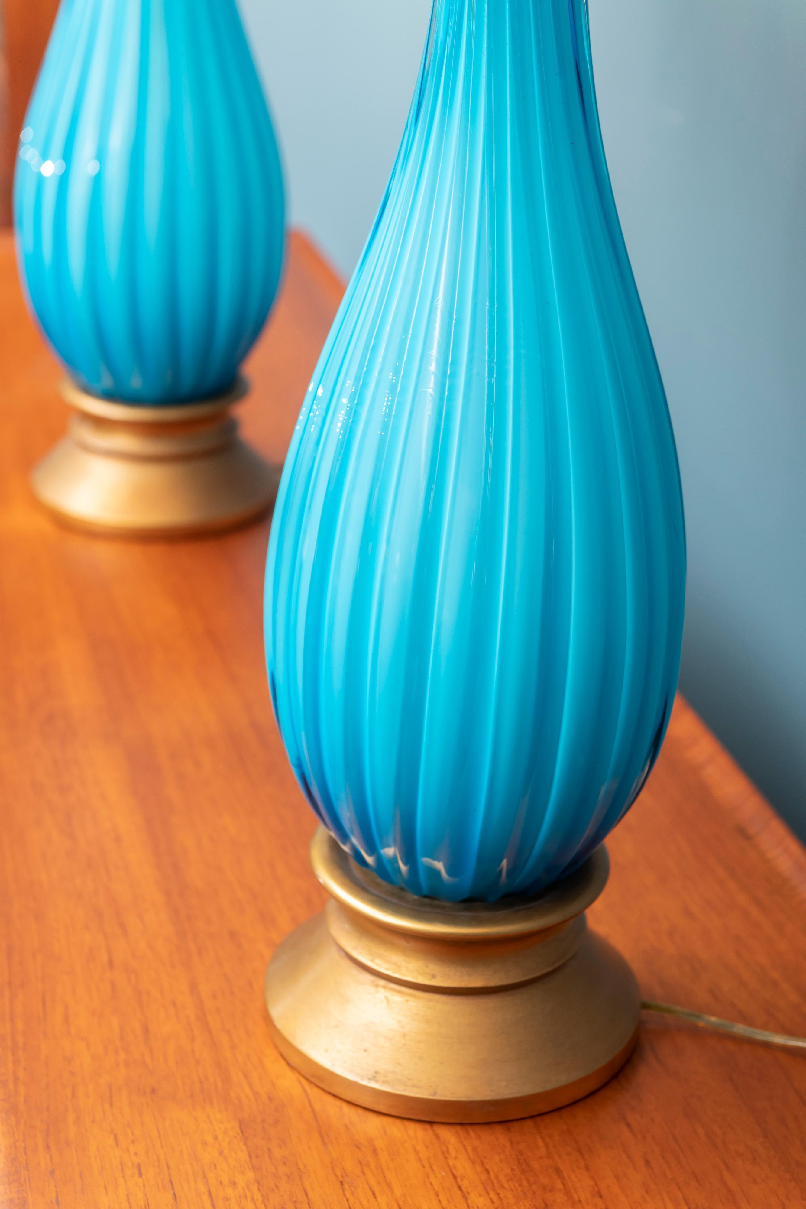 Murano glass table lamps by Mabro, Los Angeles CA. Stunning aqua blue color with brass and gilt metal mounts, shades are by association and in good condition.