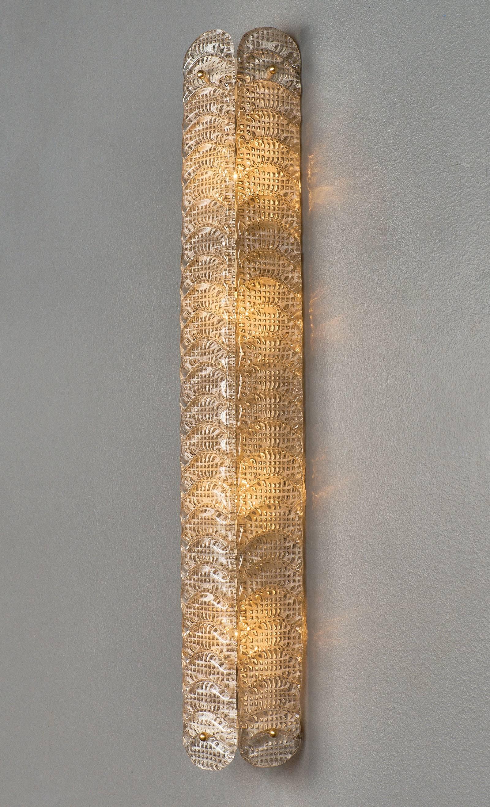 A pair of Murano glass sconces featuring three important thick glass slabs molded and textured; with white glass layered within the texture of the reverse to create a “python skin’ effect. These sconces have been wired to fit US standards.

These