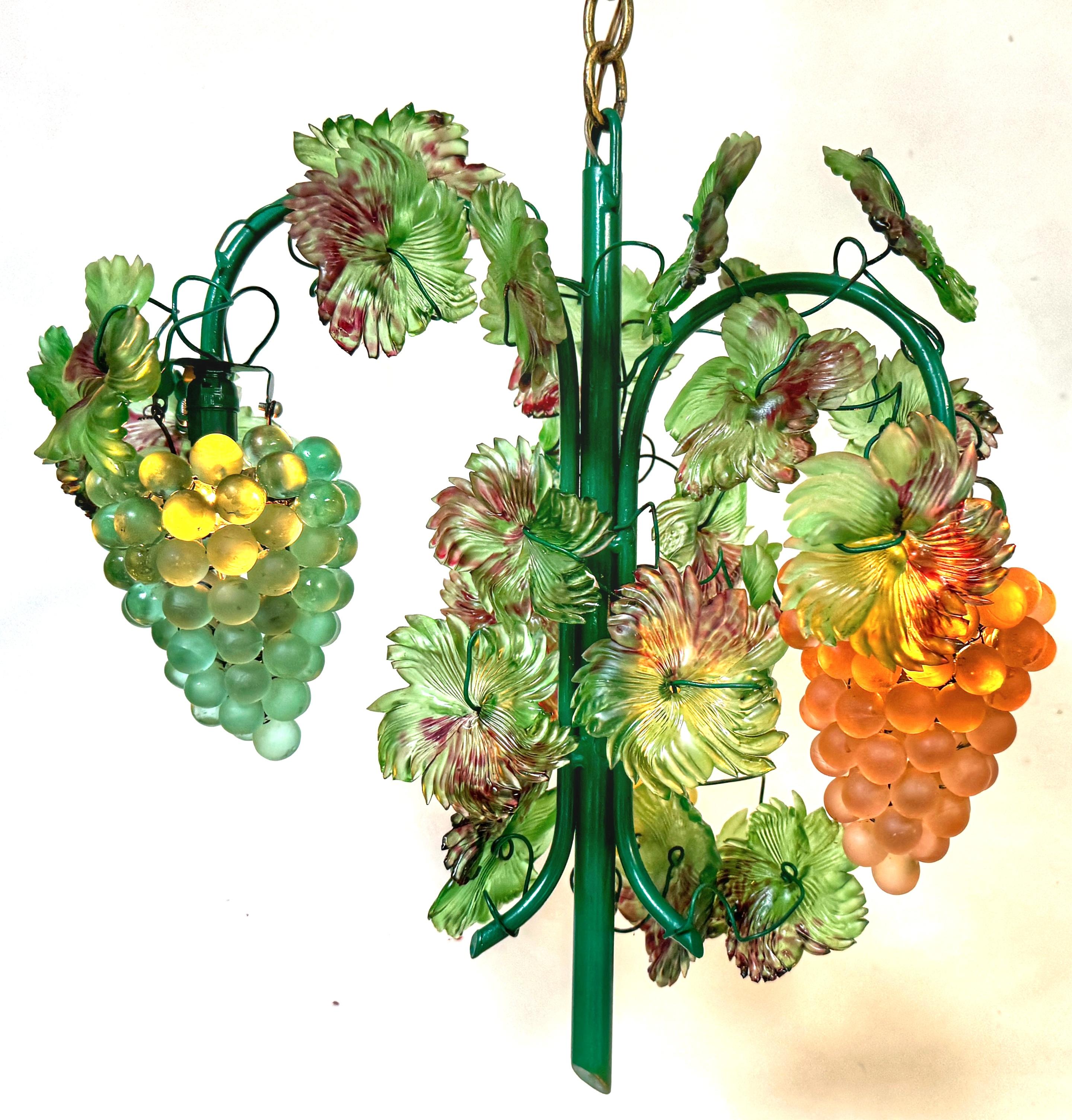 Murano Glass Triangle Hanging Clusters of Grapes and Leaves Chandelier 
Italy, circa 1950s

This exceptional Murano glass chandelier, an exquisite example of mid-20th-century Italian workmanship, features a vibrant design that is both eye-catching