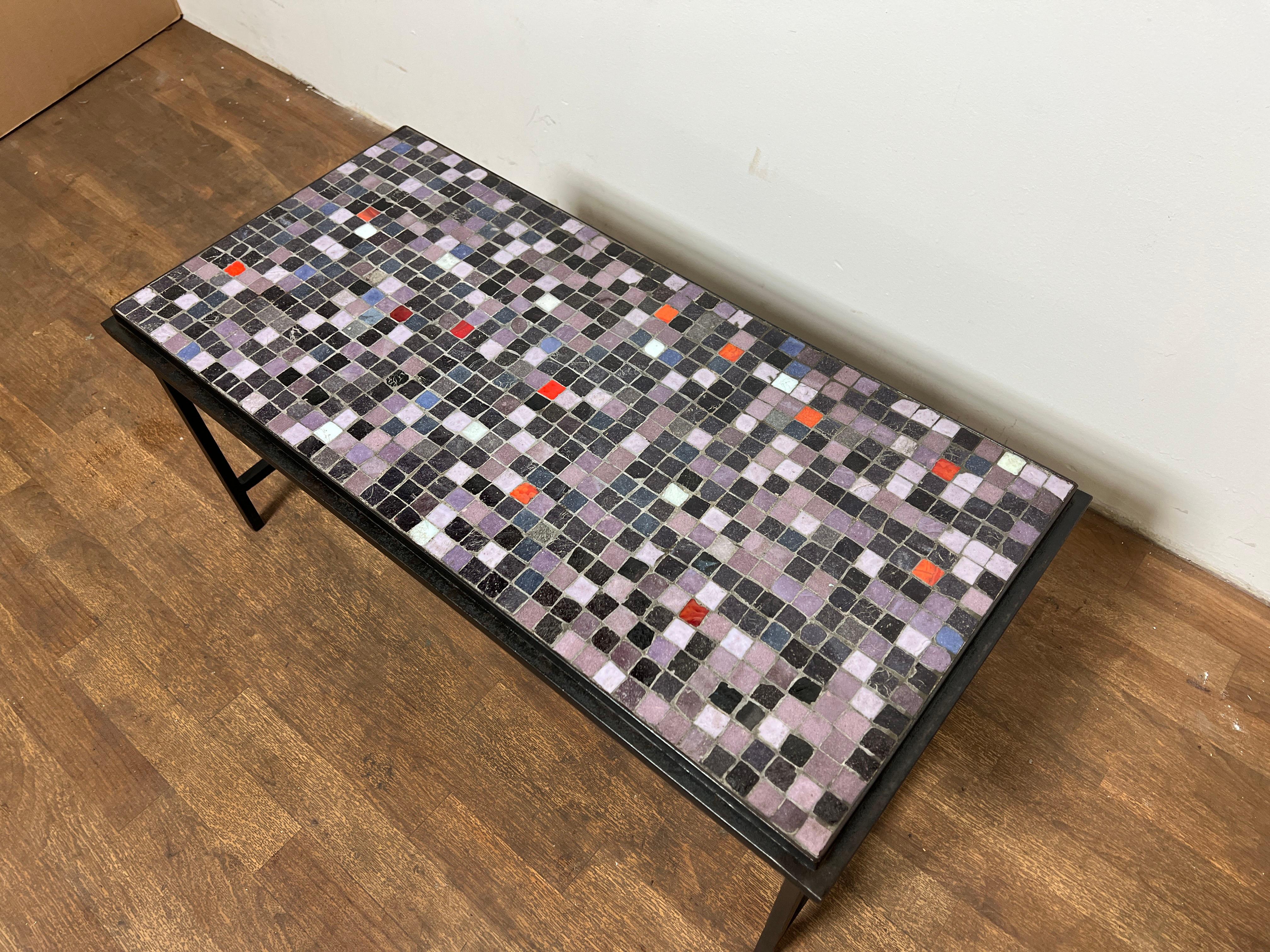 A vintage 1960s coffee table in a spare wrought iron frame with inlaid mosaic top of Murano glass tiles.